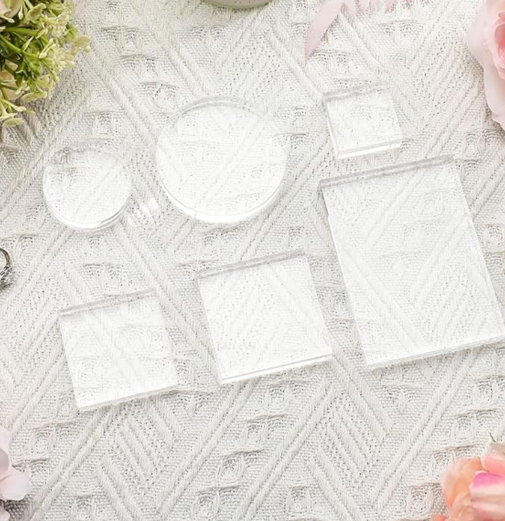 Elegant white lace textured background with round and square cutout shapes arranged in a geometric pattern.