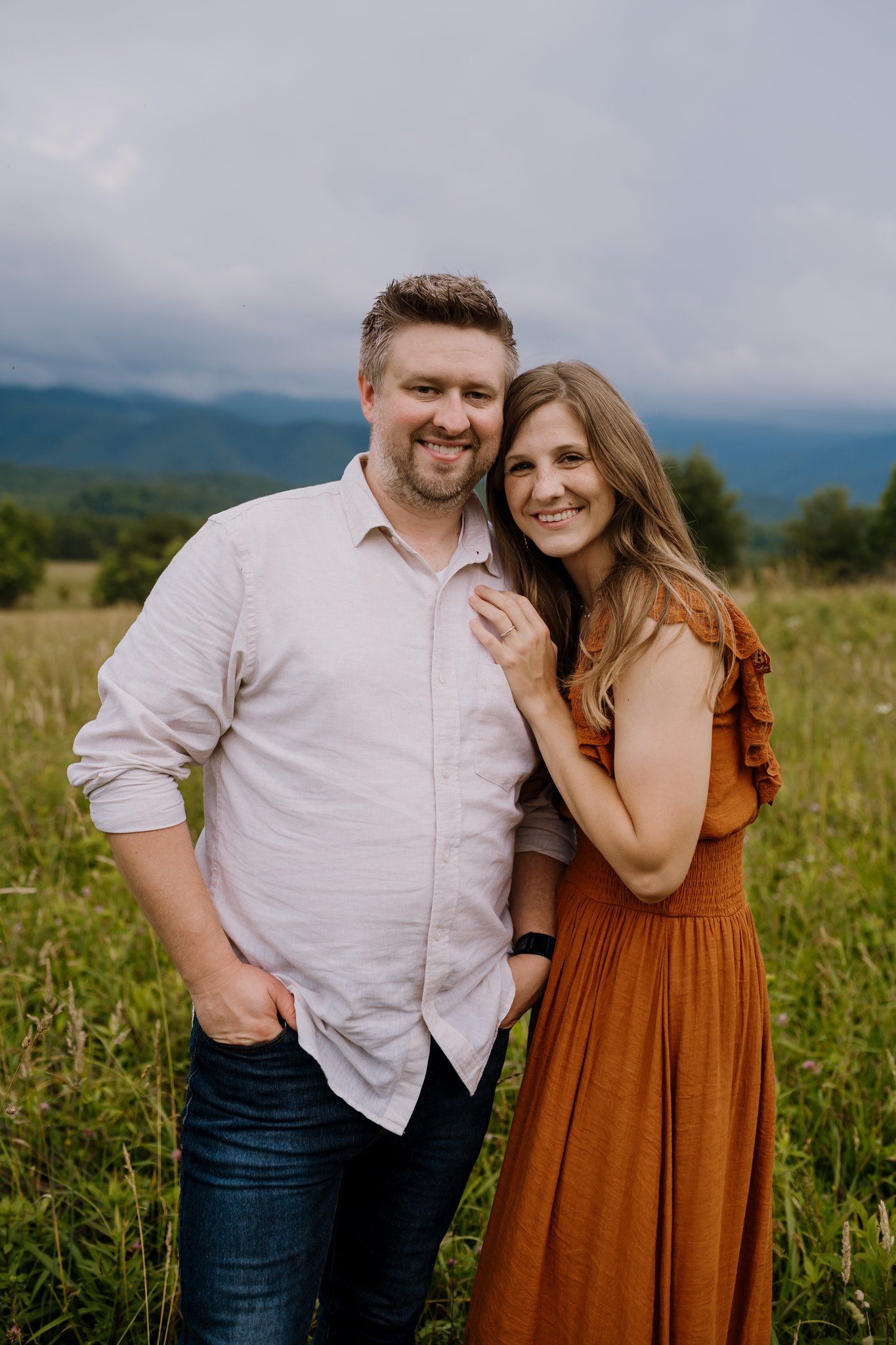 Parents smile at the camera during smoky mountains photography session