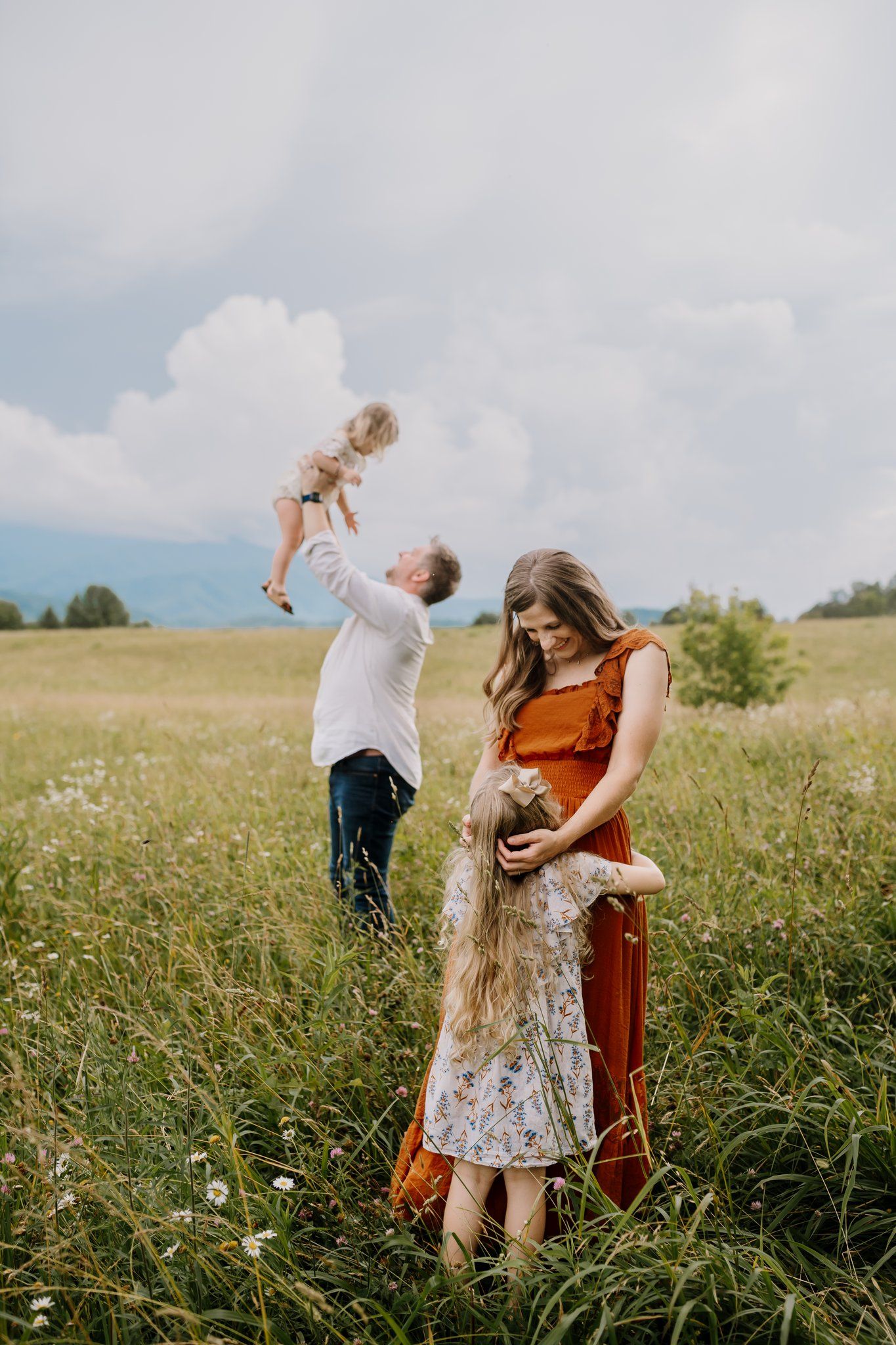 family plays with the smoky mountains in the background during family photography session in the national park