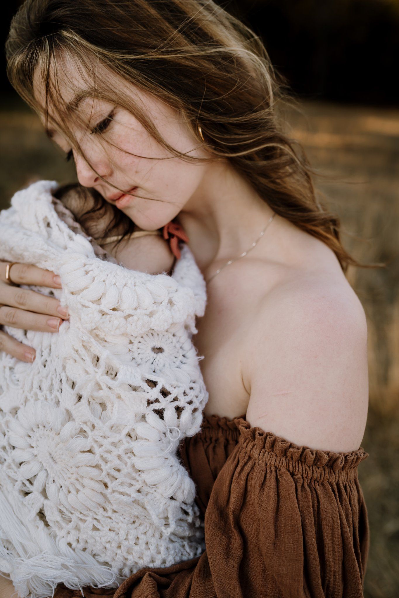 Mom snuggles baby in reclamation dress
