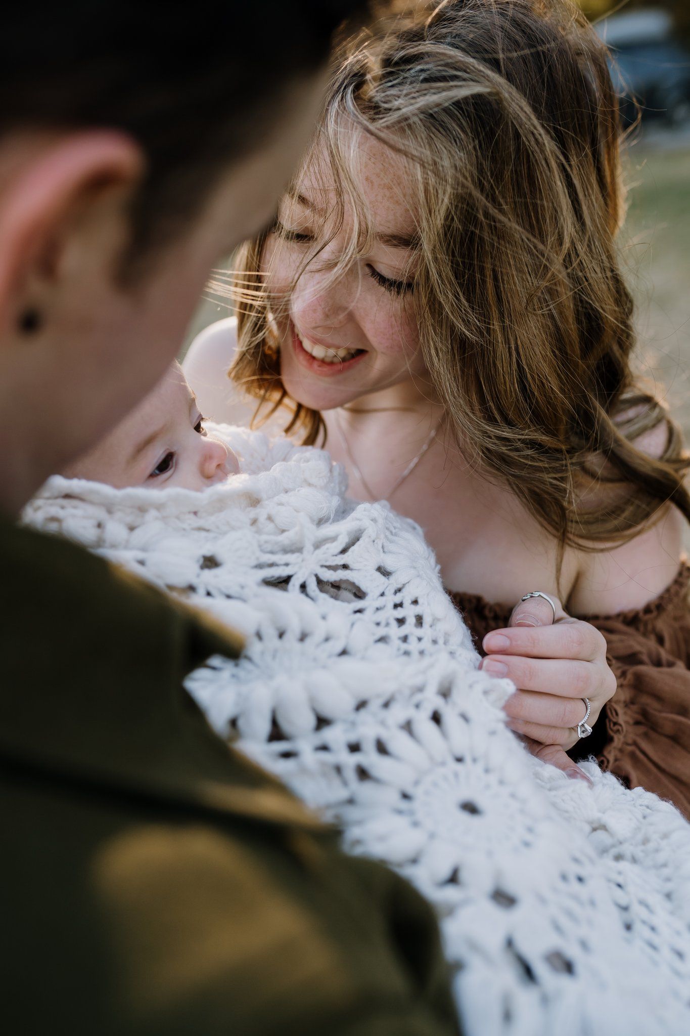 Mom plays with baby during styled family photos