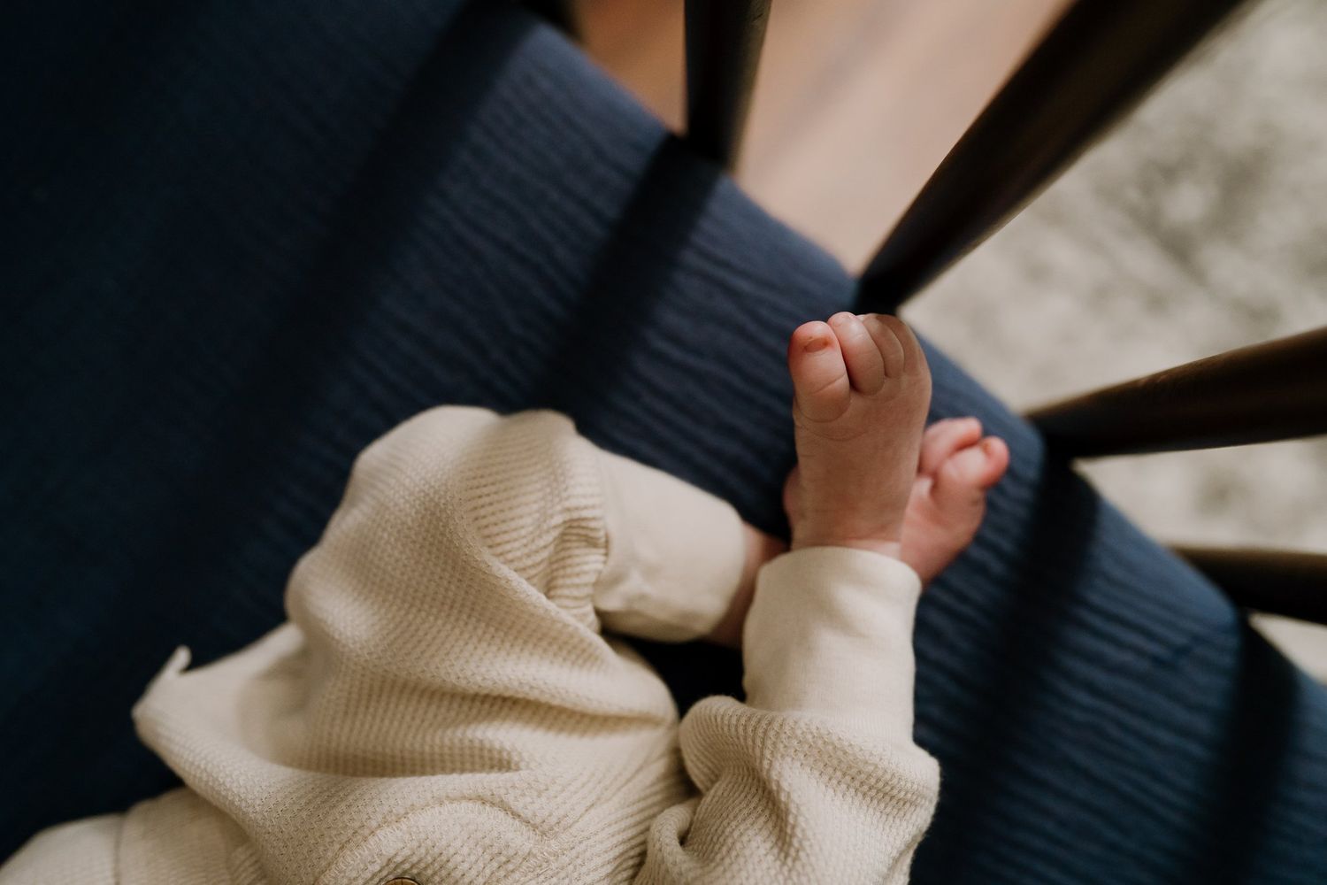 Newborn baby feet in crib