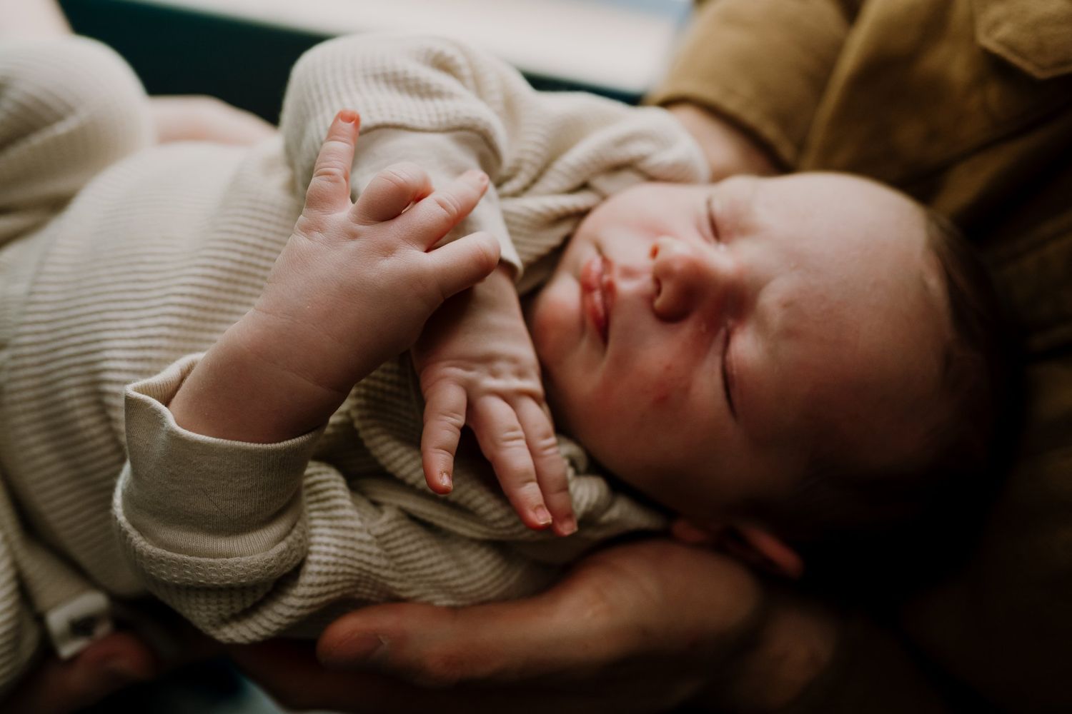 Newborn baby in dad's arms