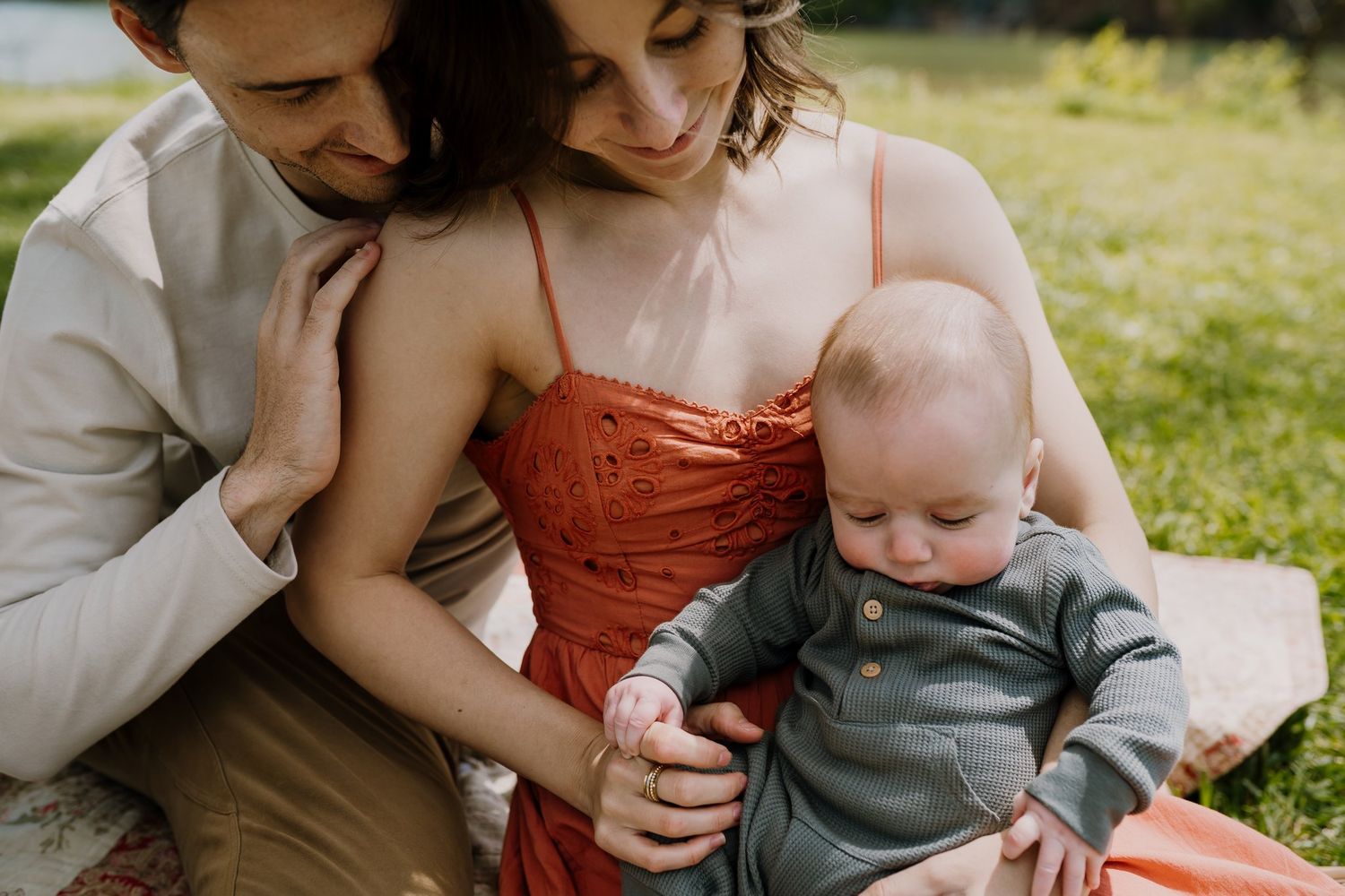 Family cuddles with baby