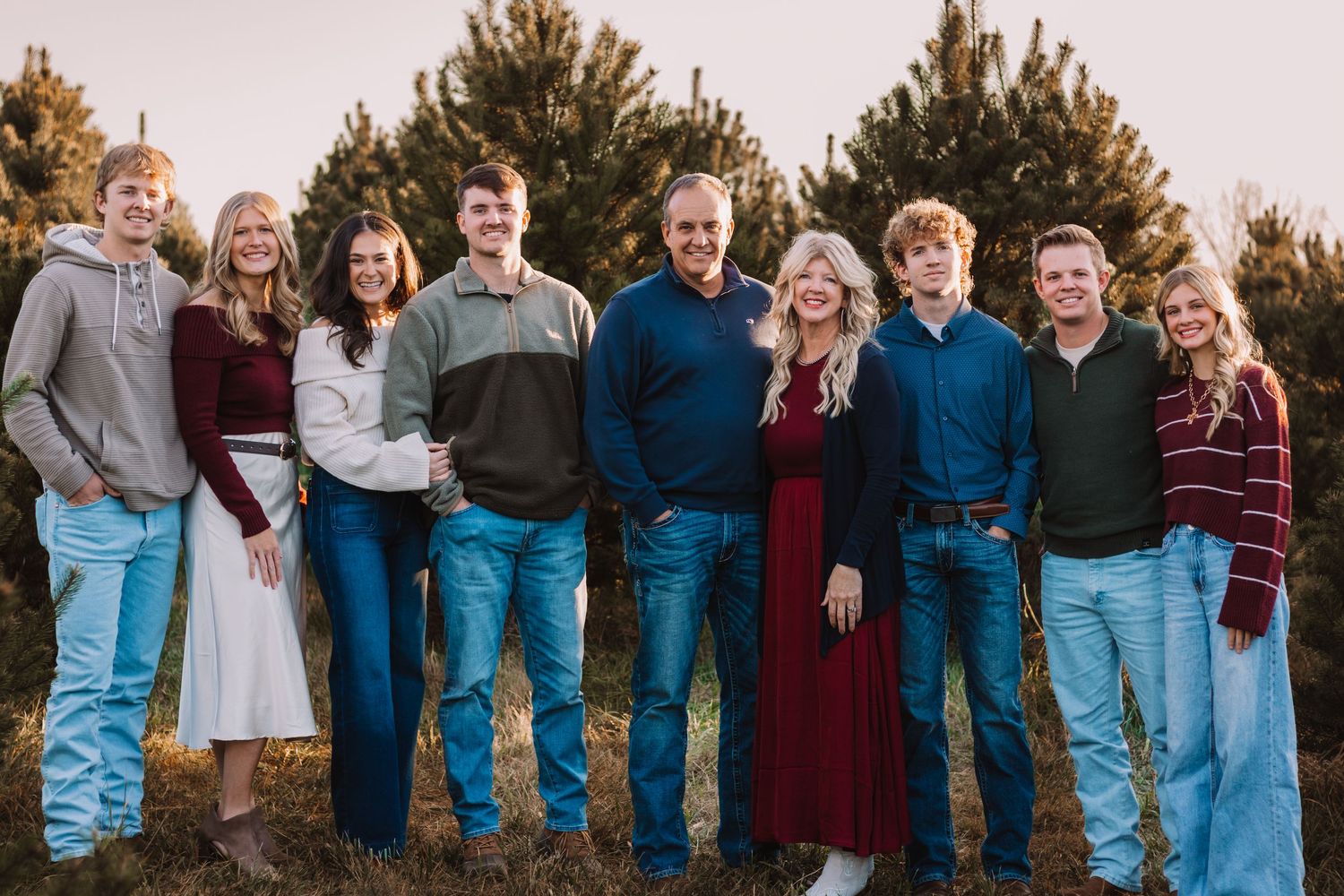 extended family in a Christmas tree farm for christmas