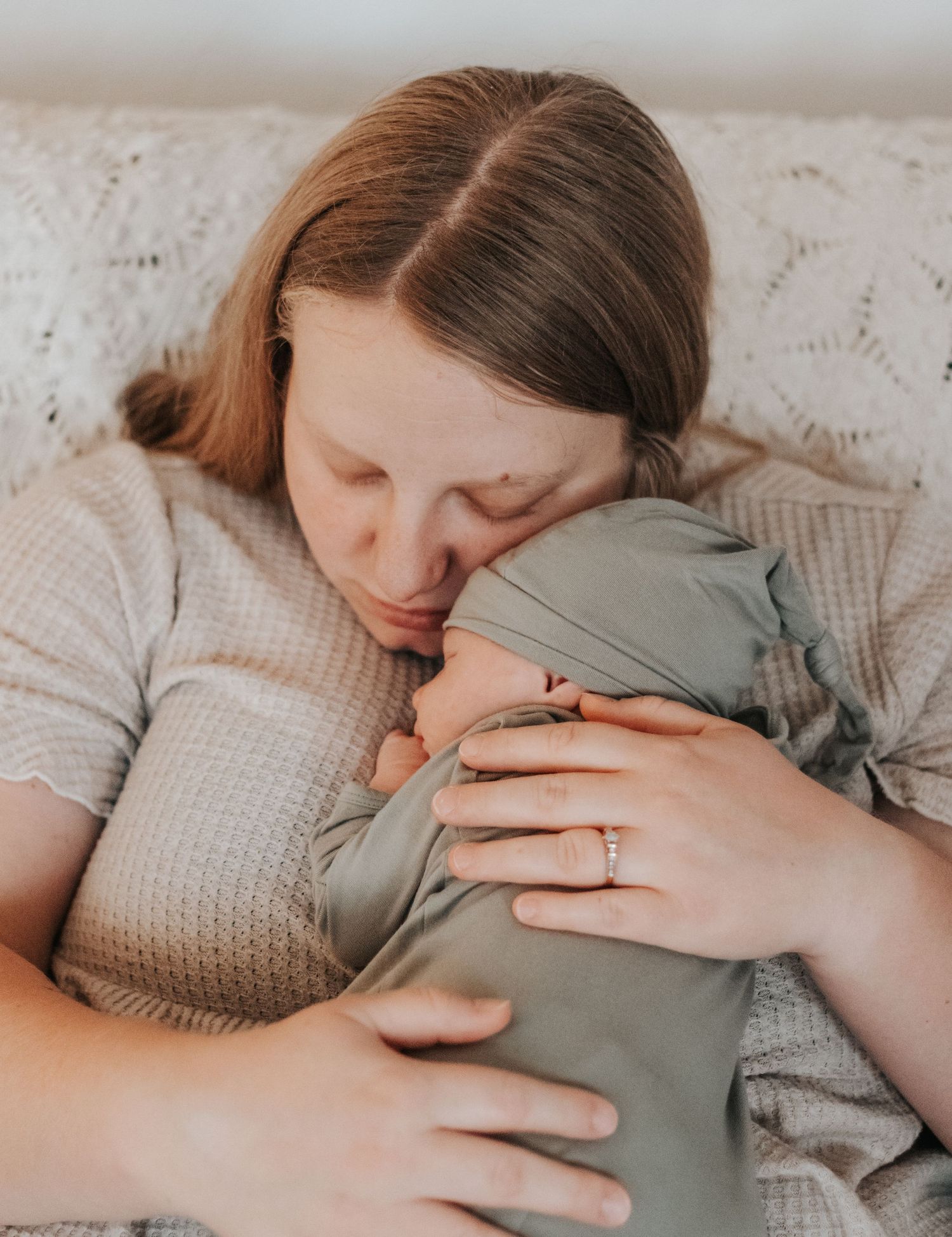 new mother holding newborn baby in home newborn lifestyle session in lewis county Washington