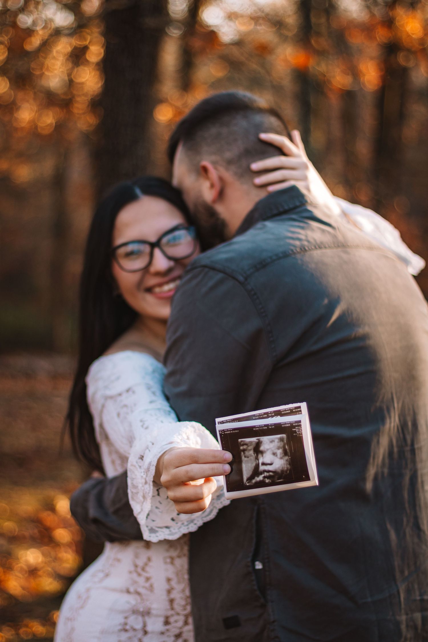 expecting mother holding sonogram with her spouse in lewis county Washington
