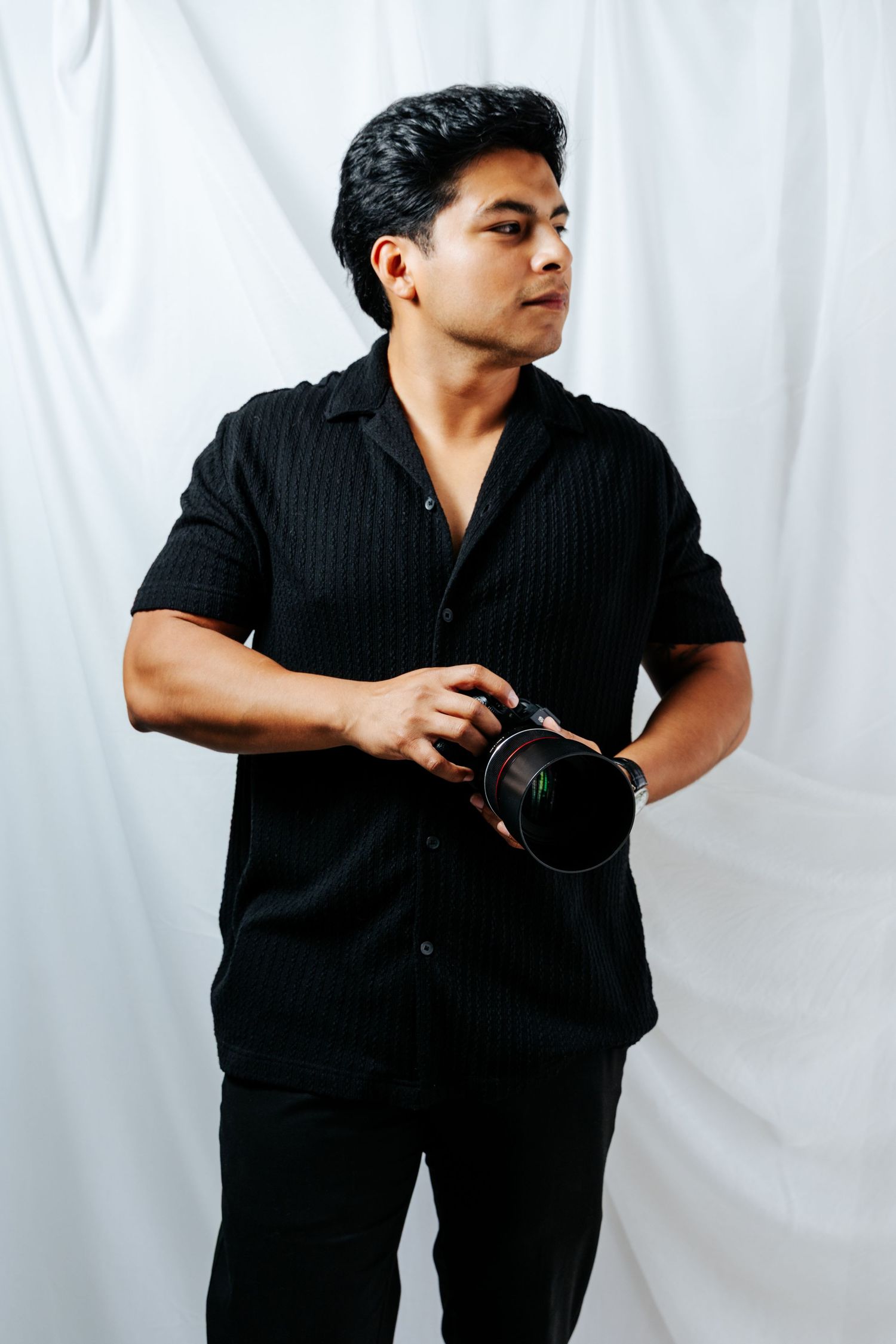 A person in black clothing strikes dynamic poses against a white background in a triptych photo series.