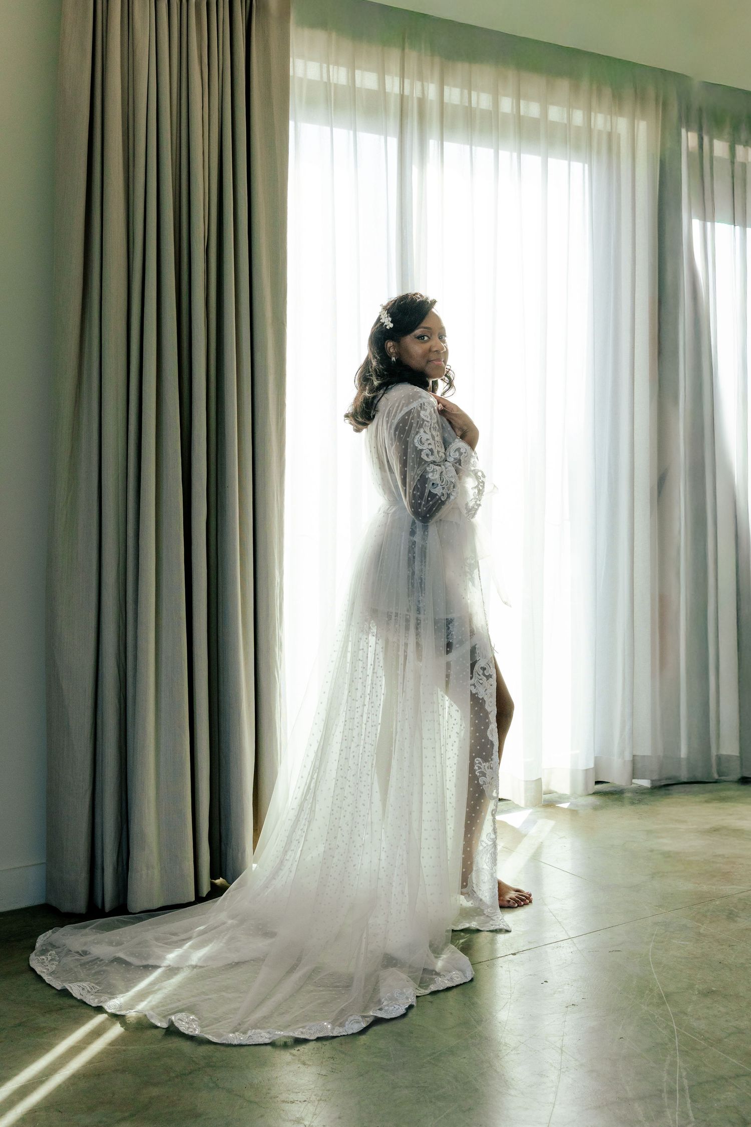A sequence of photos showing a flowing white wedding dress with train captured in different angles against sheer curtains.