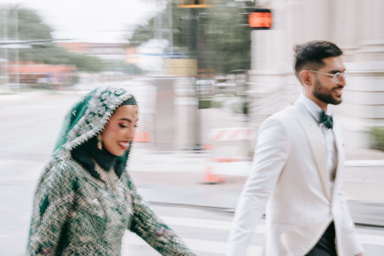 A couple walks together outdoors in winter, with one person wearing a gray coat and another in white attire.