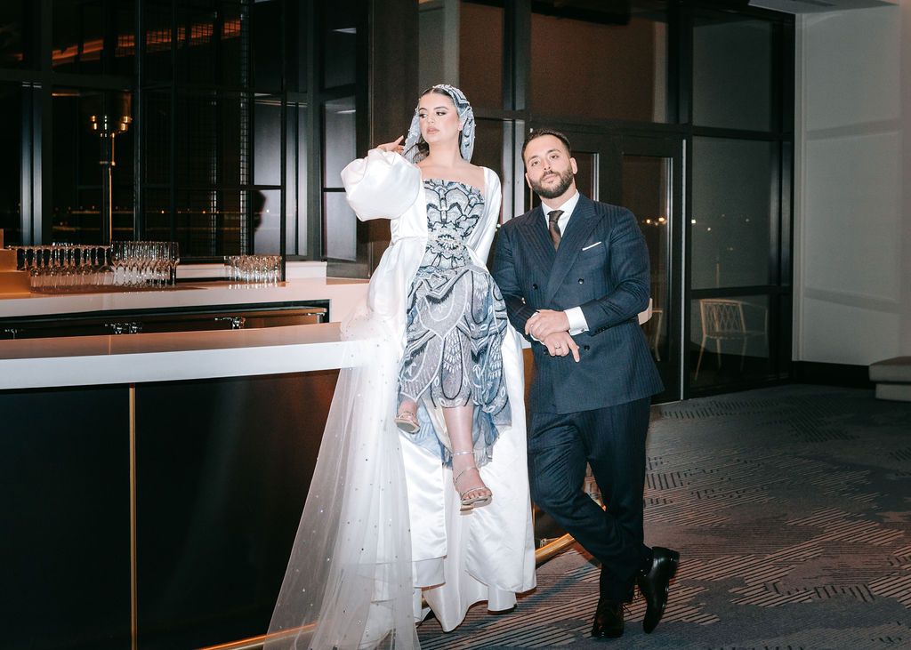 A celebratory moment captured at an evening wedding reception with elegant decor.