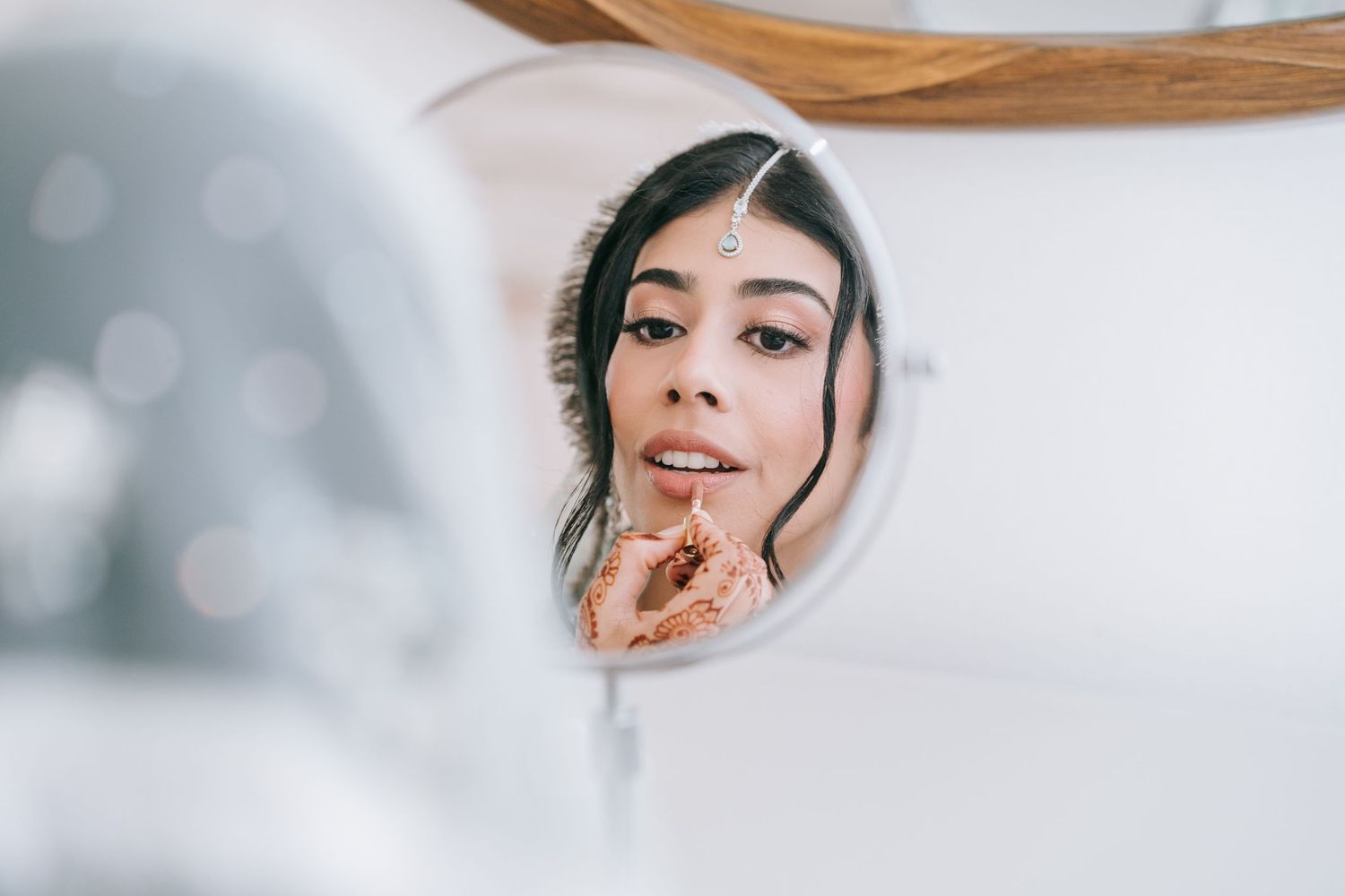 Dallas wedding bride putting on makeup on her wedding day.