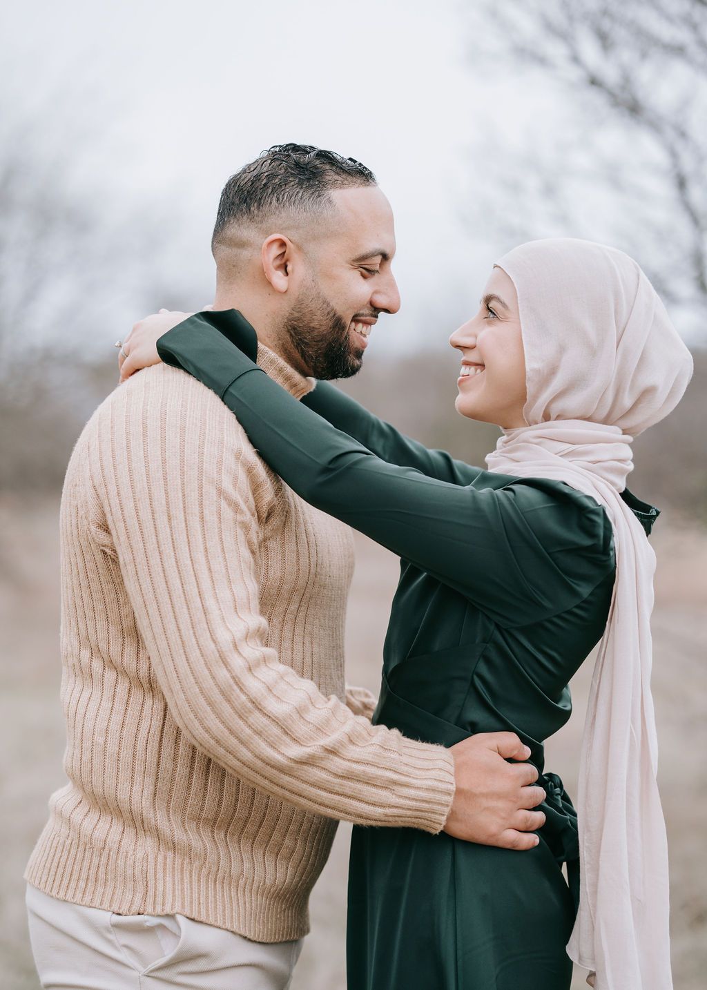 Intimate outdoor portrait of couple in casual wear sharing joyful moment together.