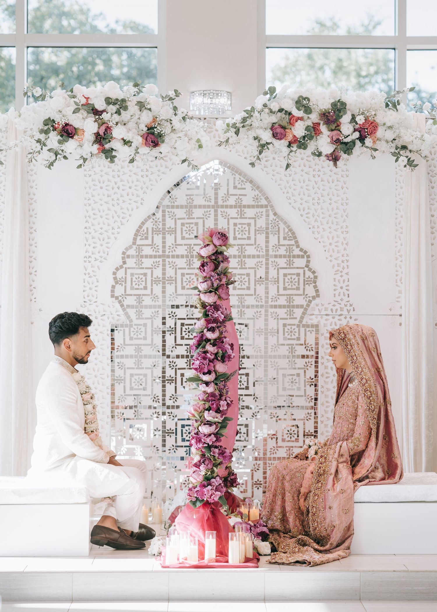 Pakistani Dallas wedding couple standing across from each other with a curtain between them.