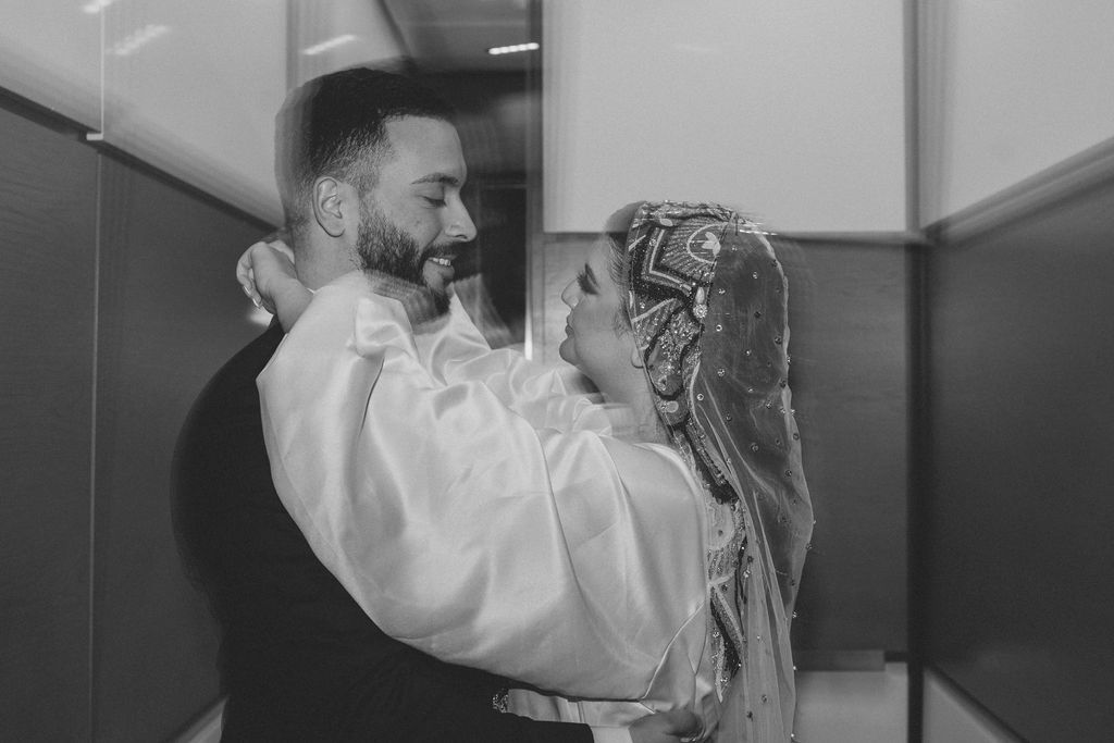 A black and white portrait of a couple sharing an intimate dance moment.