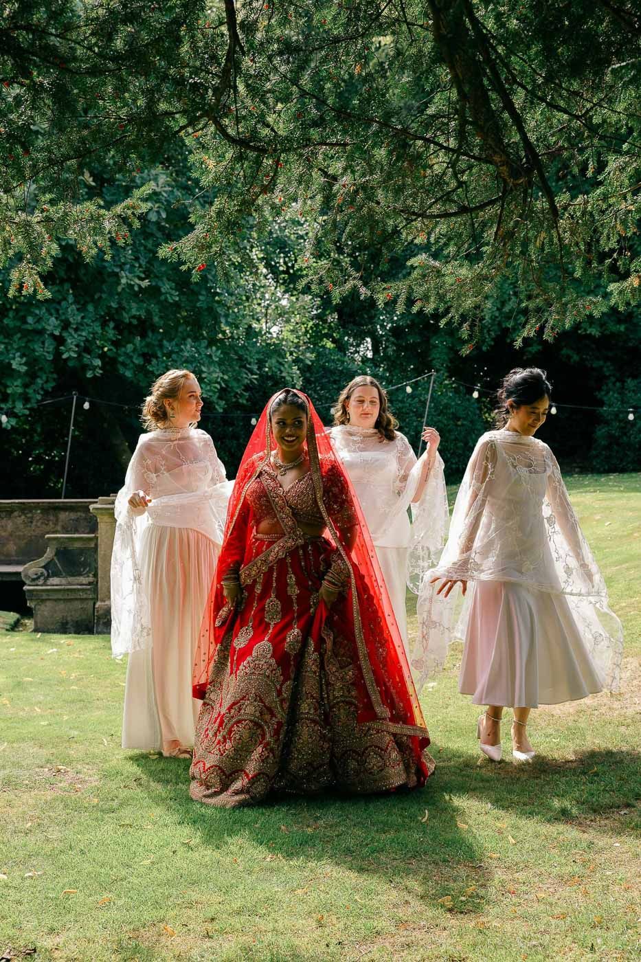 Bride walking with bridesmaids during a Scottish wedding celebration