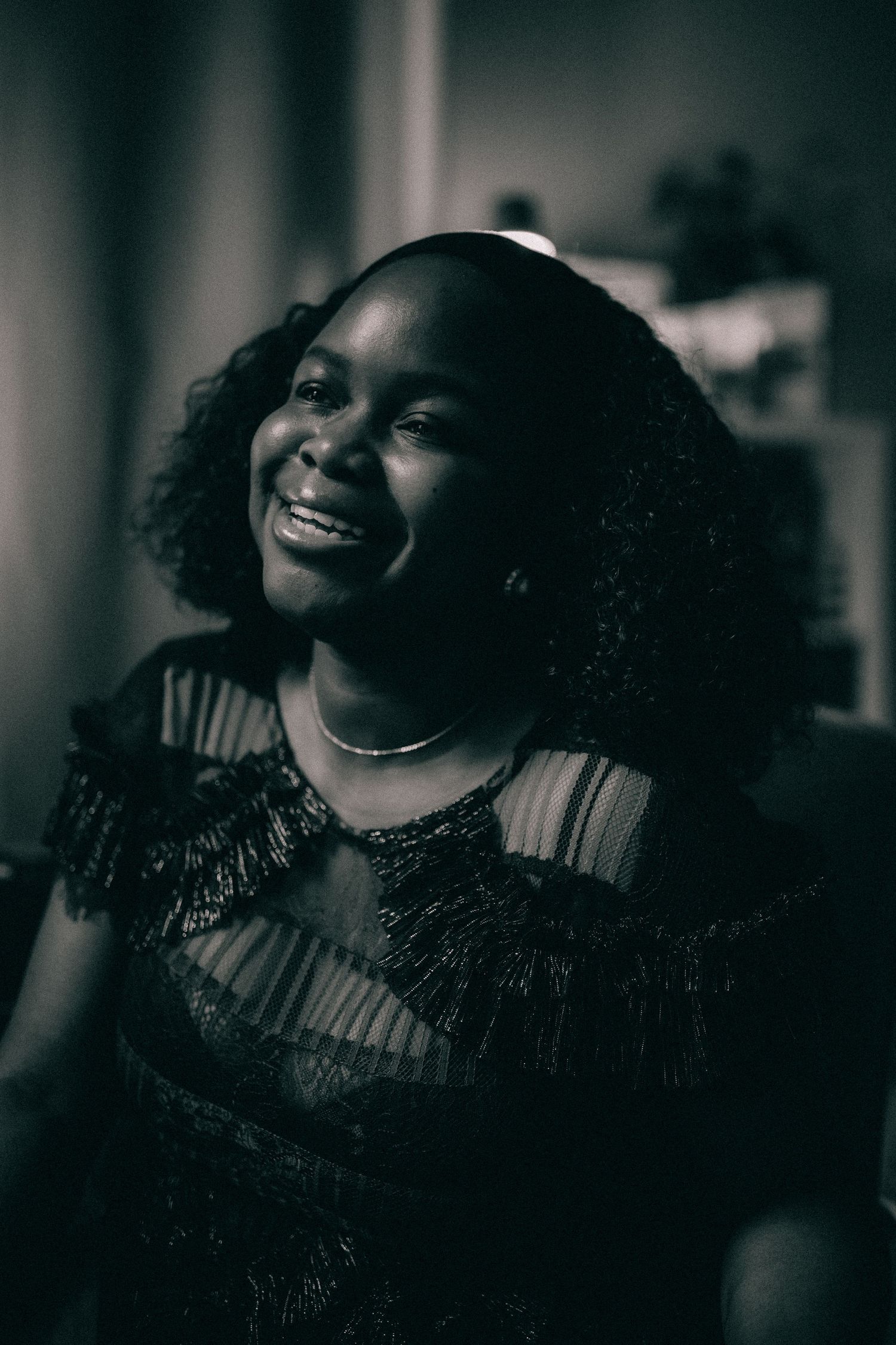 Black and white portrait series showing joyful expressions and natural curly hair.