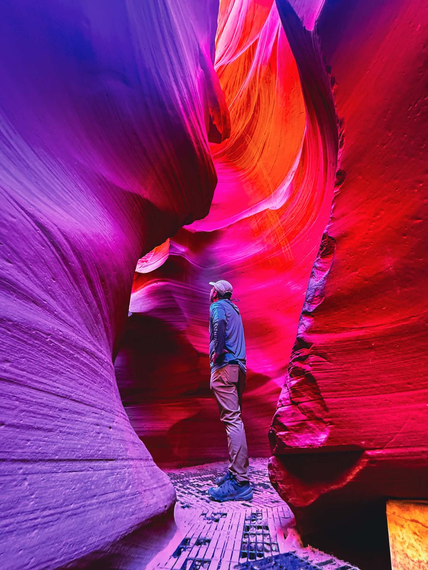 Adventure portrait inside Antelope Canyon with vibrant sandstone walls glowing in the sunlight.