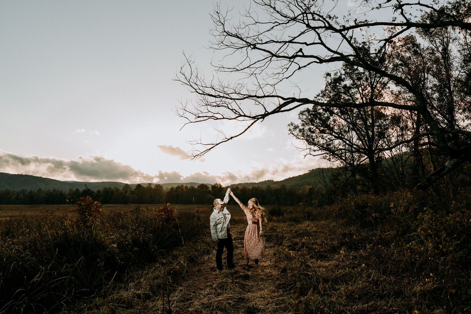 Engagement portraits in Cades Cove with scenic Smoky Mountain views.
