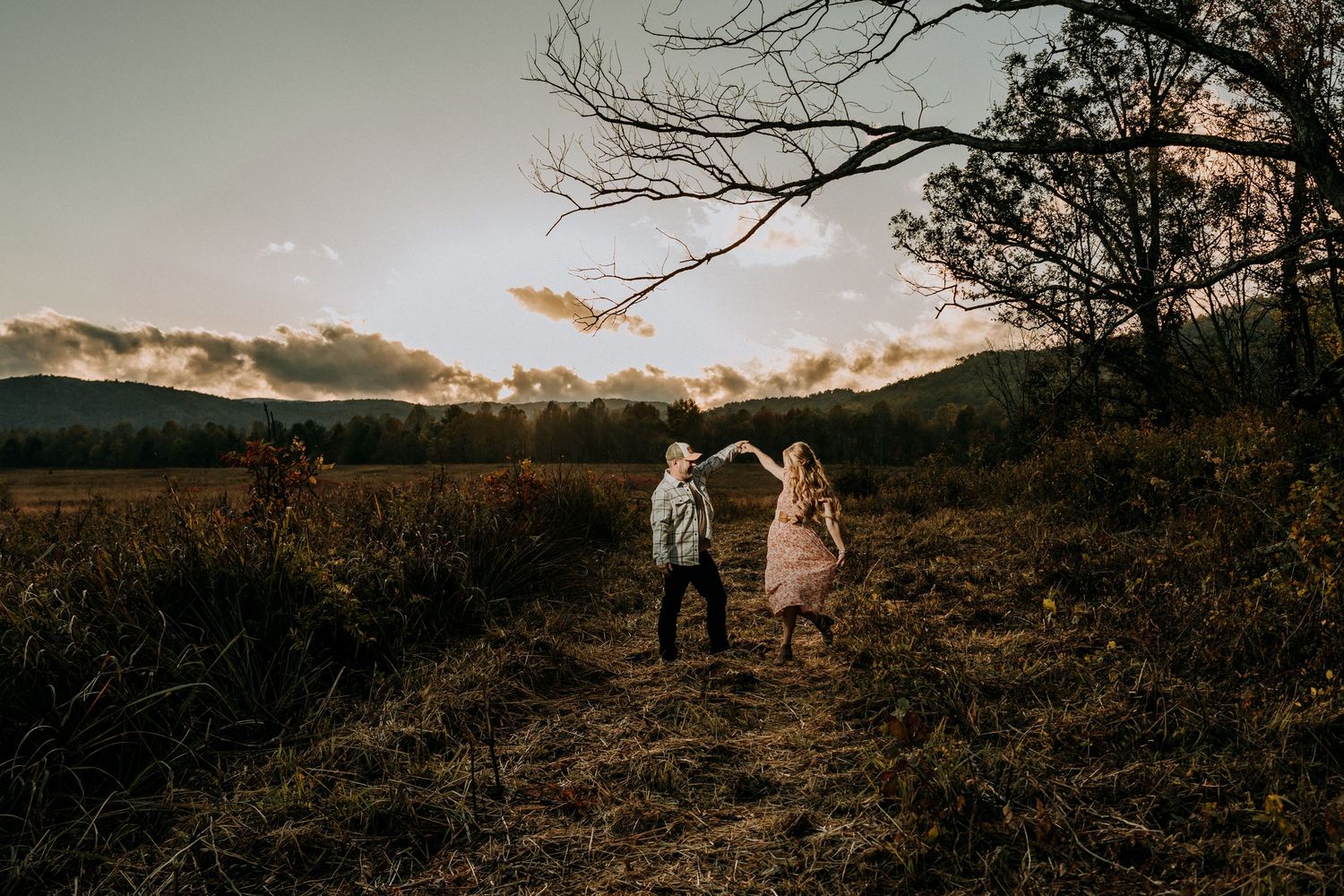 Engagement portraits in Cades Cove with scenic Smoky Mountain views.