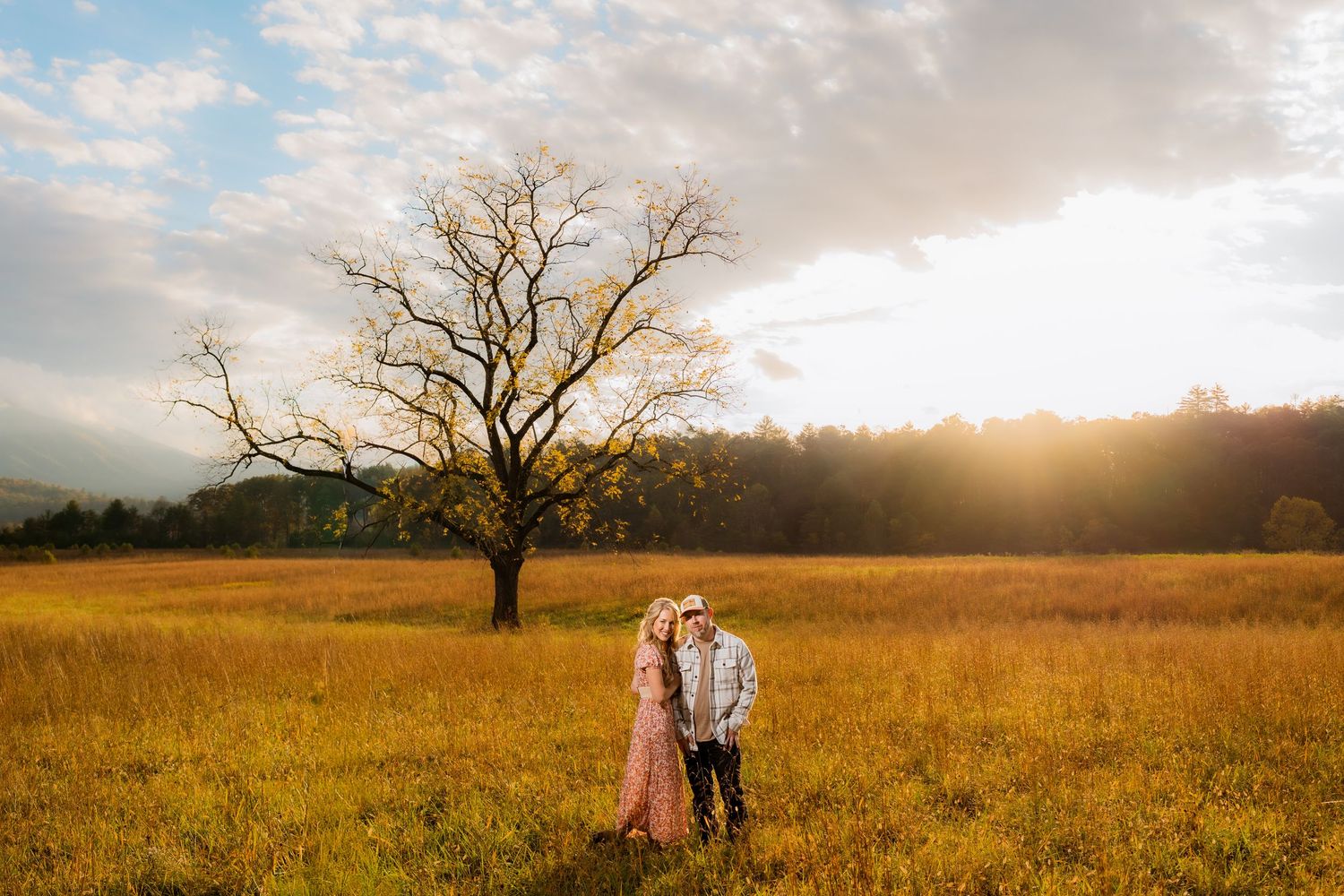 Engagement portraits in Cades Cove with scenic Smoky Mountain views.