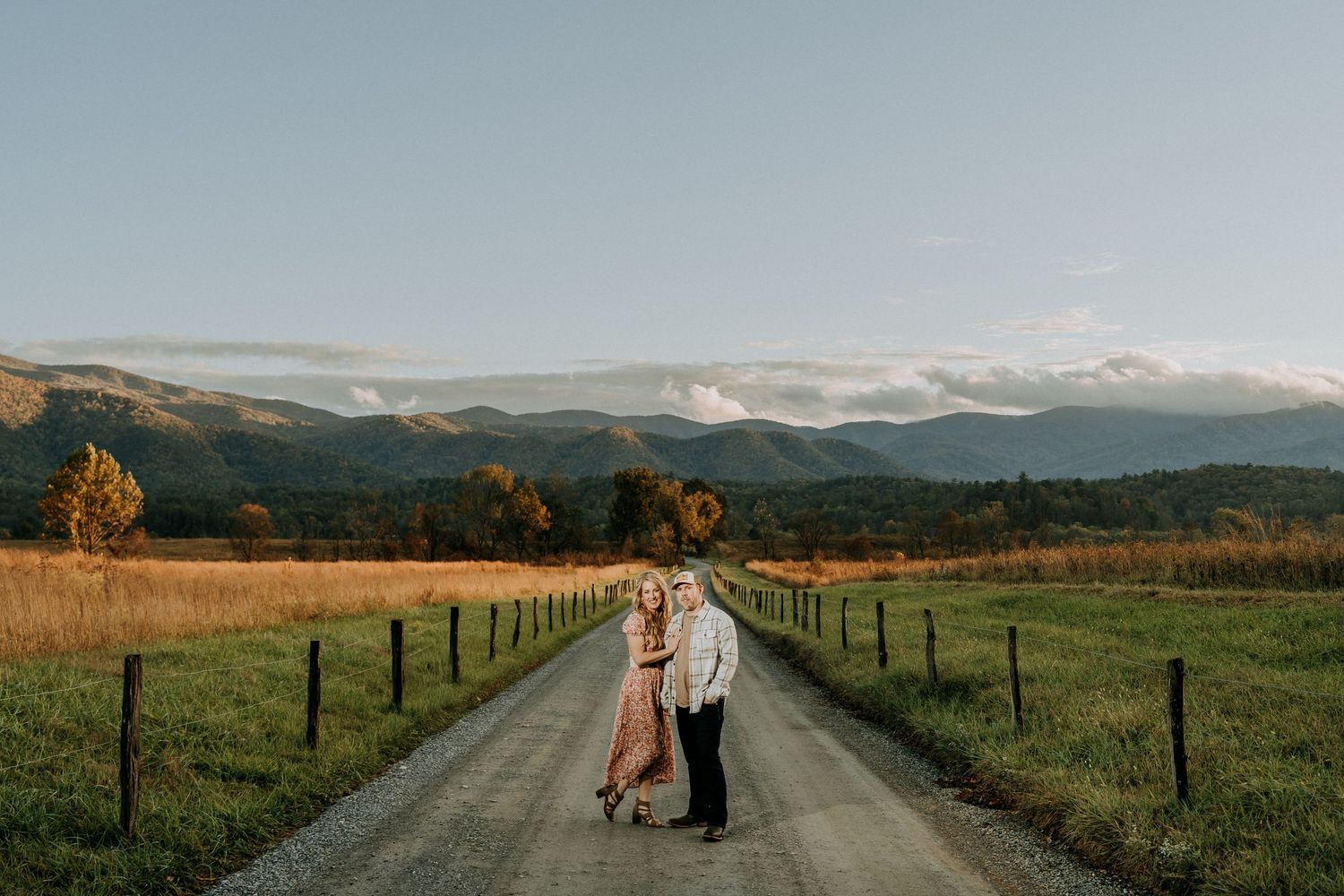 Engagement portraits in Cades Cove with scenic Smoky Mountain views.