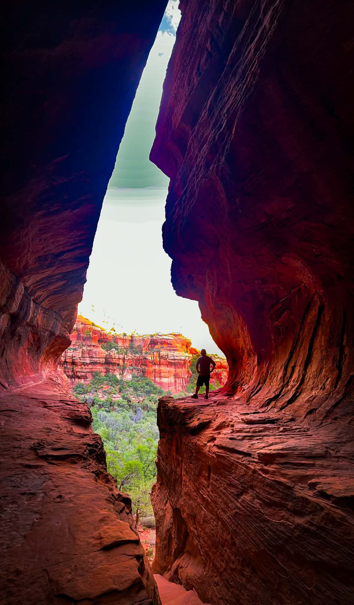 Adventure portrait inside Subway Cave in Sedona, Arizona, surrounded by dramatic red rock formations and the rugged beauty of the Southwest.