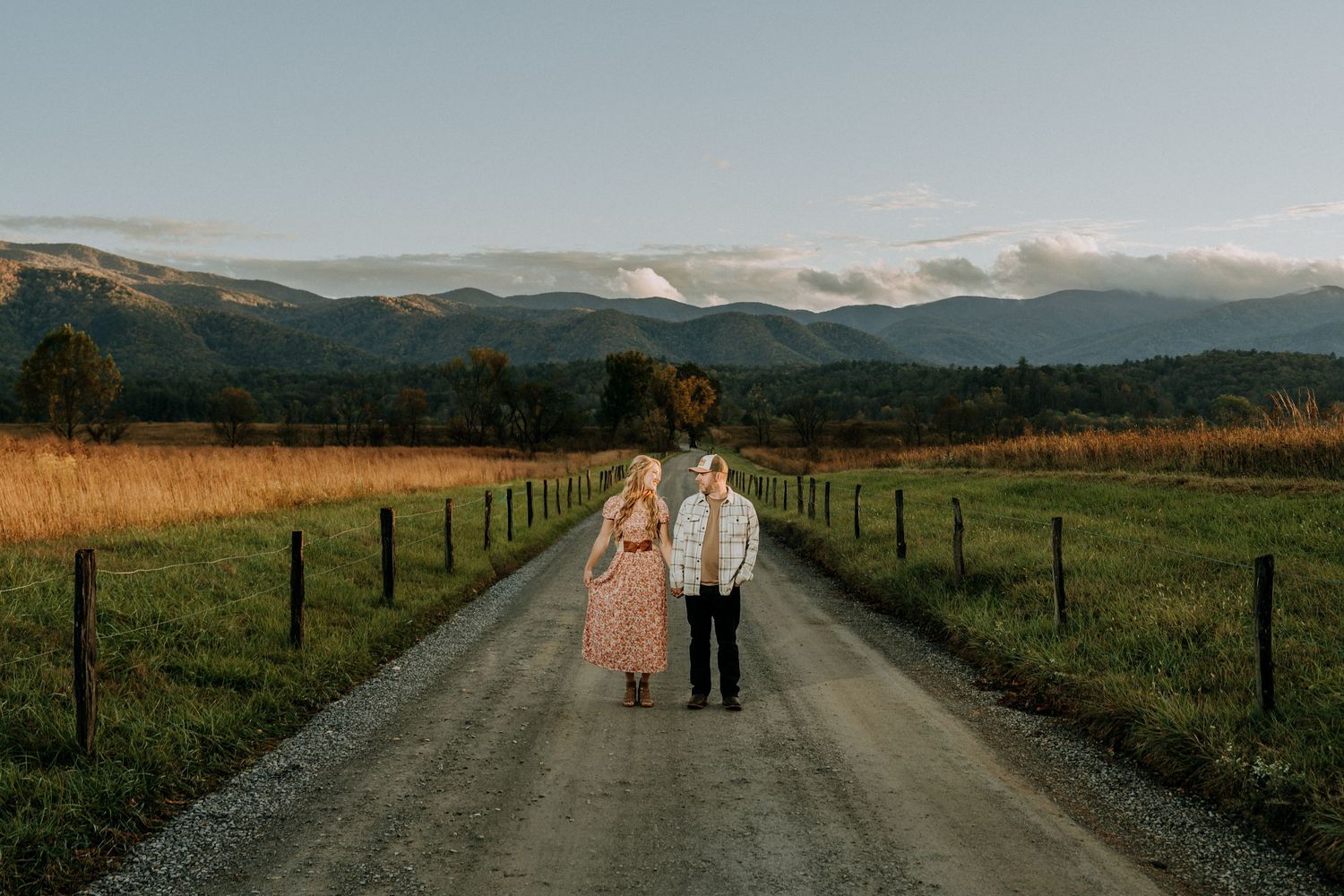 Engagement portraits in Cades Cove with scenic Smoky Mountain views.