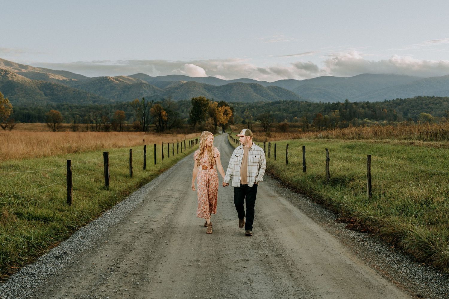Engagement portraits in Cades Cove with scenic Smoky Mountain views.