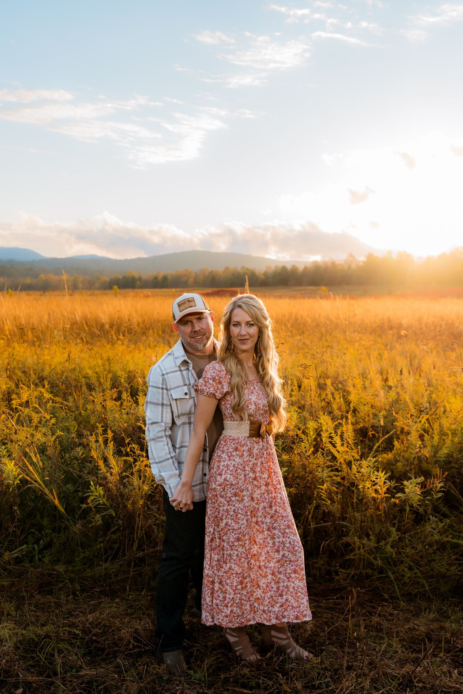 Engagement portraits in Cades Cove with scenic Smoky Mountain views.