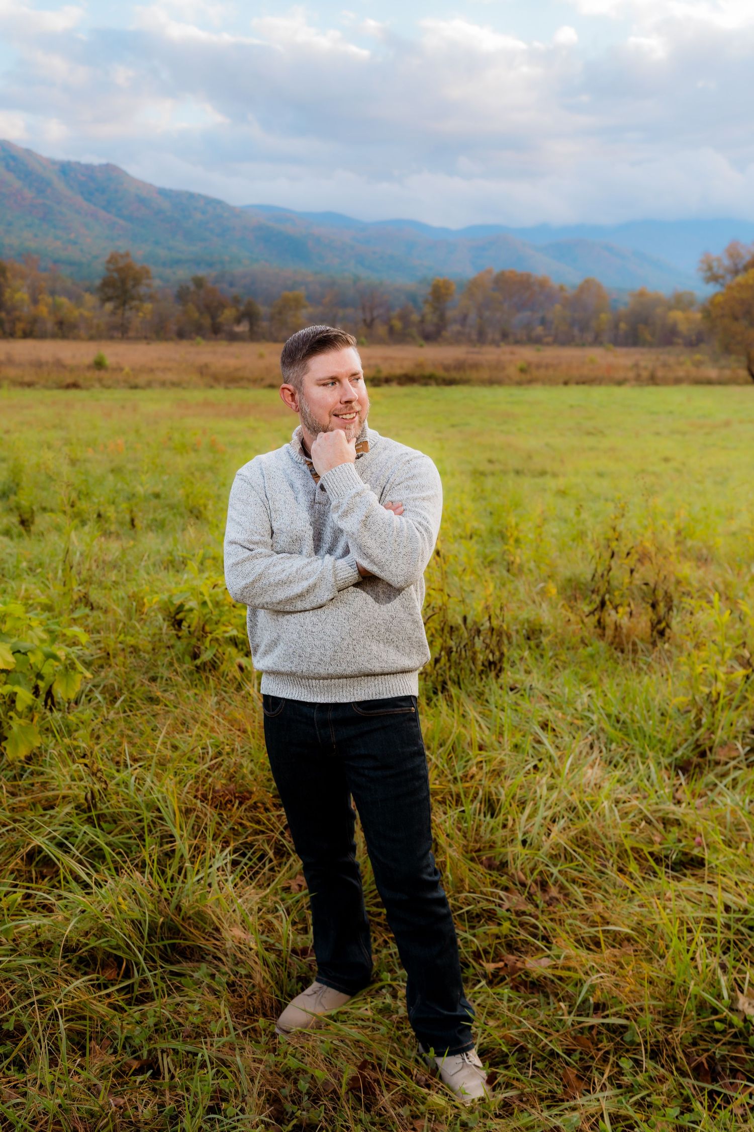 Engagement portraits in Cades Cove with scenic Smoky Mountain views.