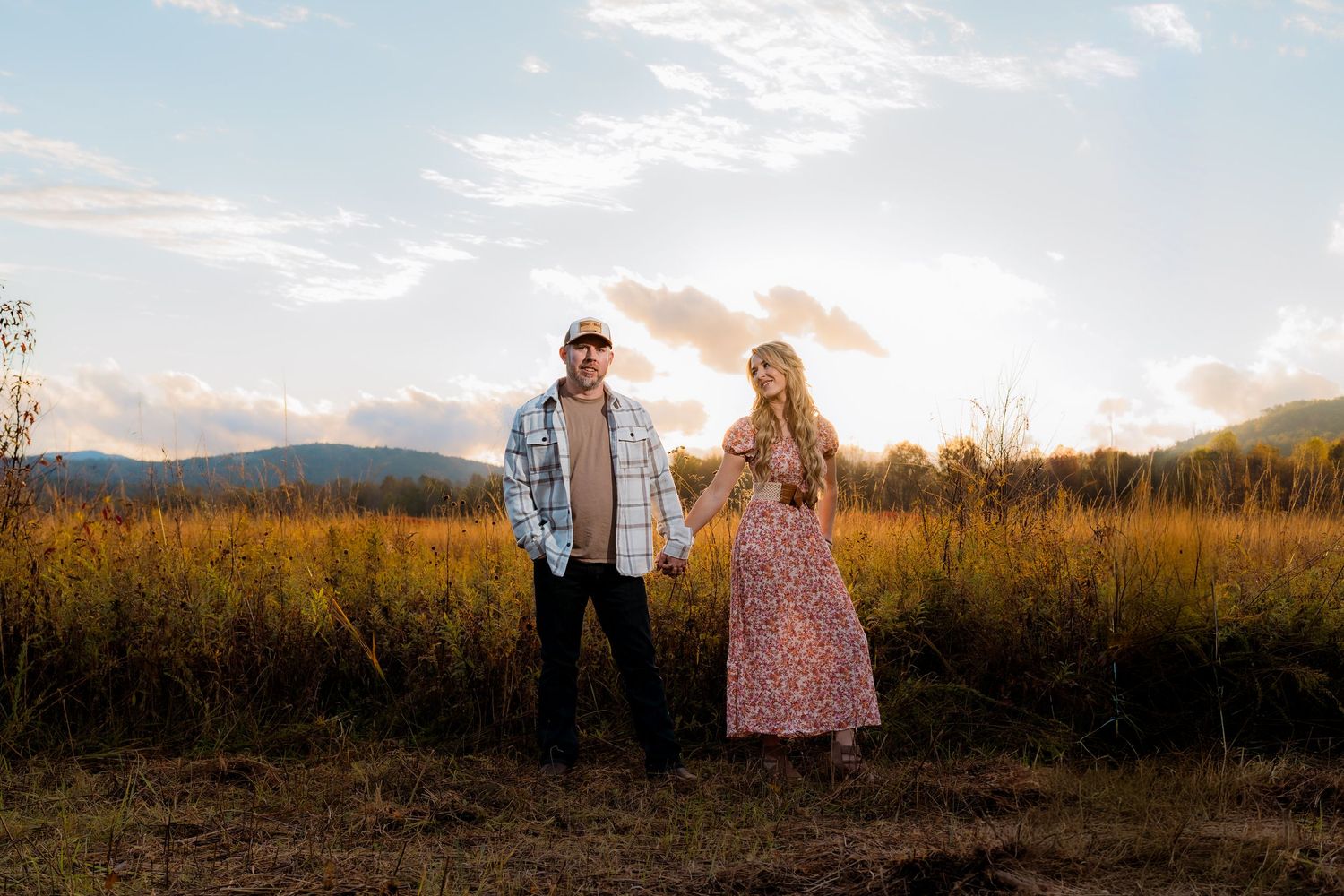 Engagement portraits in Cades Cove with scenic Smoky Mountain views.