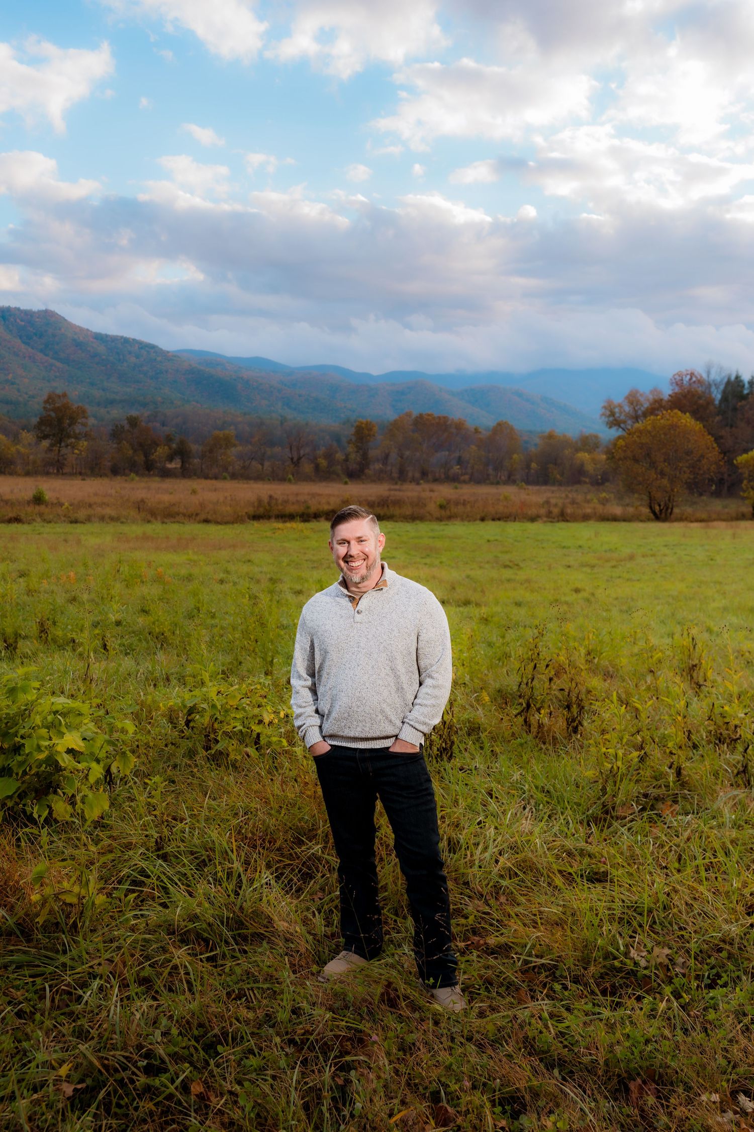 Engagement portraits in Cades Cove with scenic Smoky Mountain views.