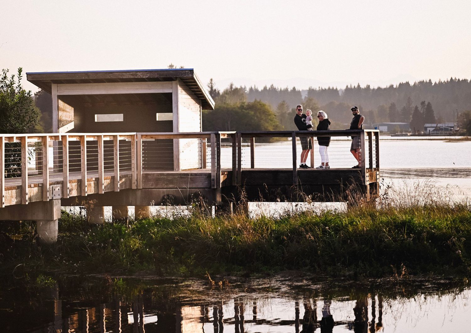 A family on a boardwalk at the Tyee Spit Estuary.