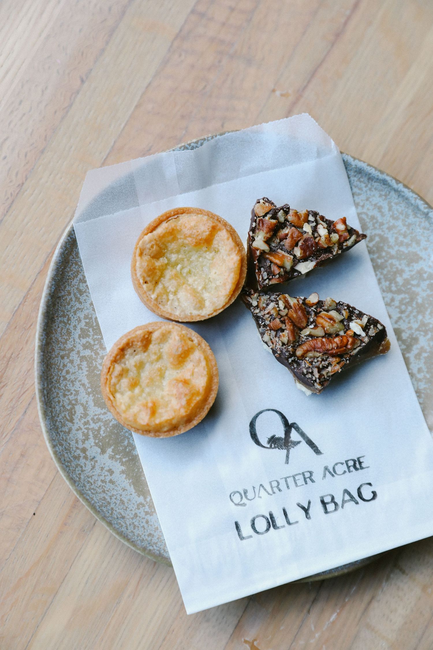 Quarter Acre restaurant lolly bag with mini custard tarts and chocolate almond bark.