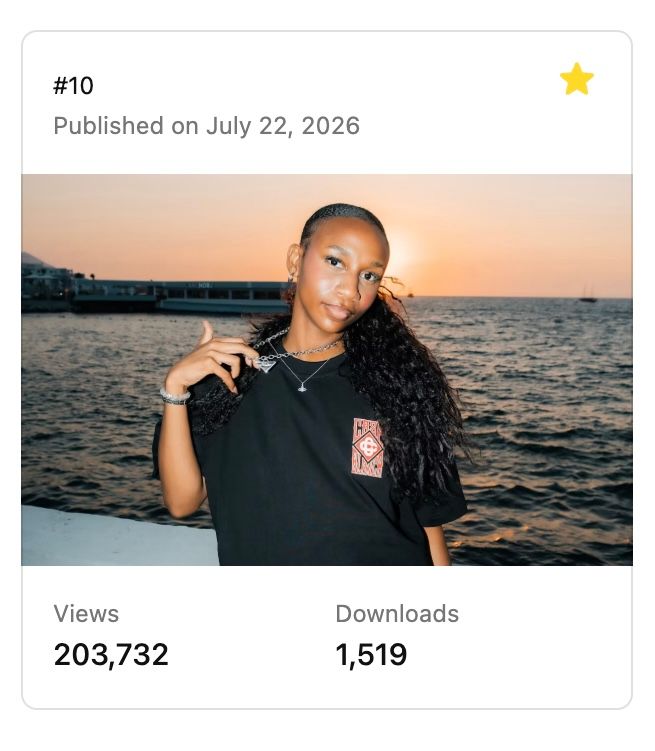 Young woman in black graphic tee posing on a boat at sunset over calm ocean waters.