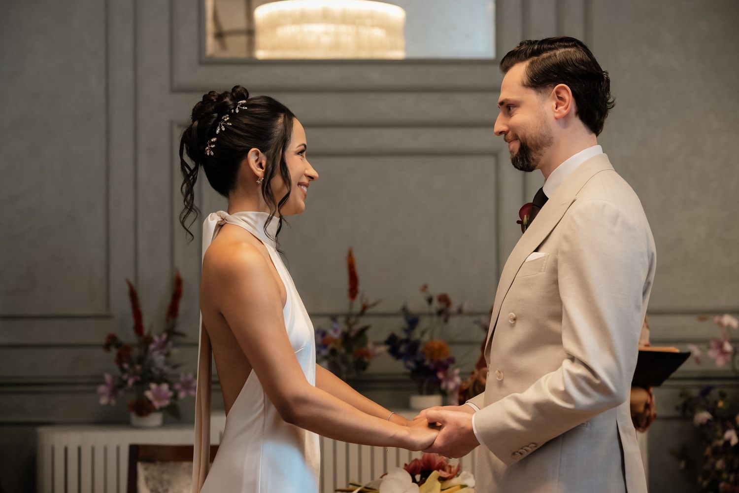 Bride and groom exchange vows, gazing lovingly at each other during their elegant wedding ceremony.