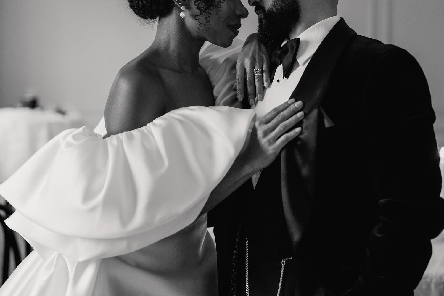 Black and white photo of bride and groom sharing an intimate moment during their wedding ceremony.
