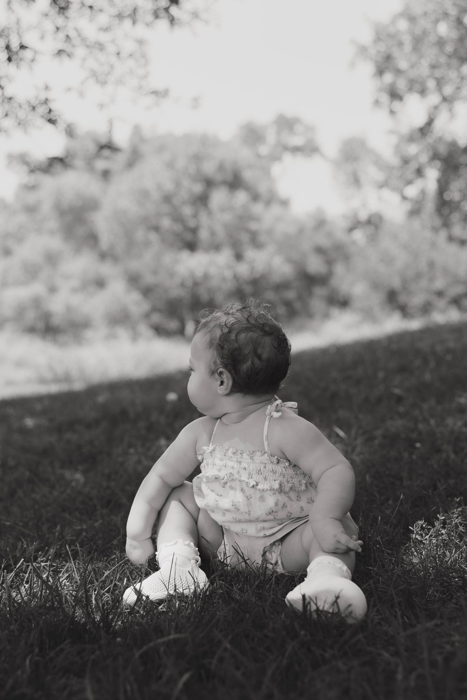 Toddler sitting in the grass during an outdoor family session