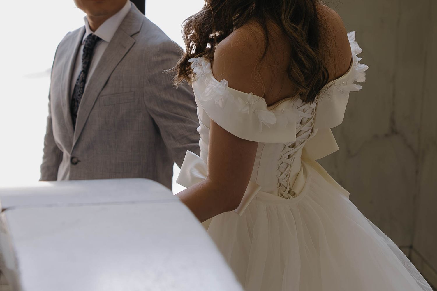 Bride showing the details of her wedding dress