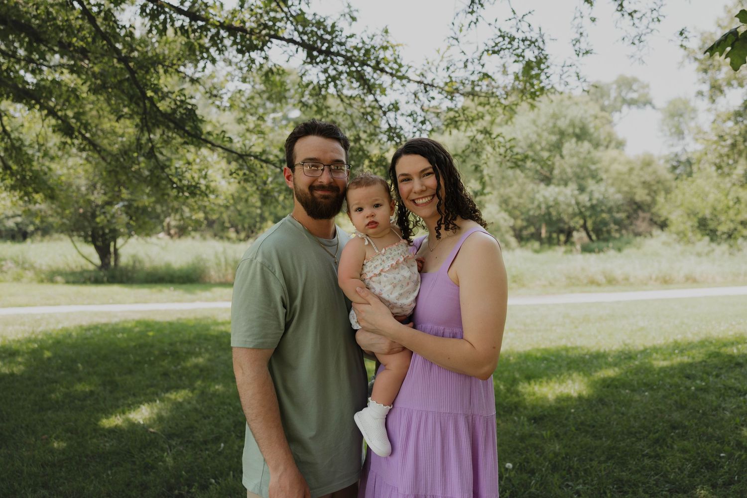 Young family of three enjoying an outdoor portrait session