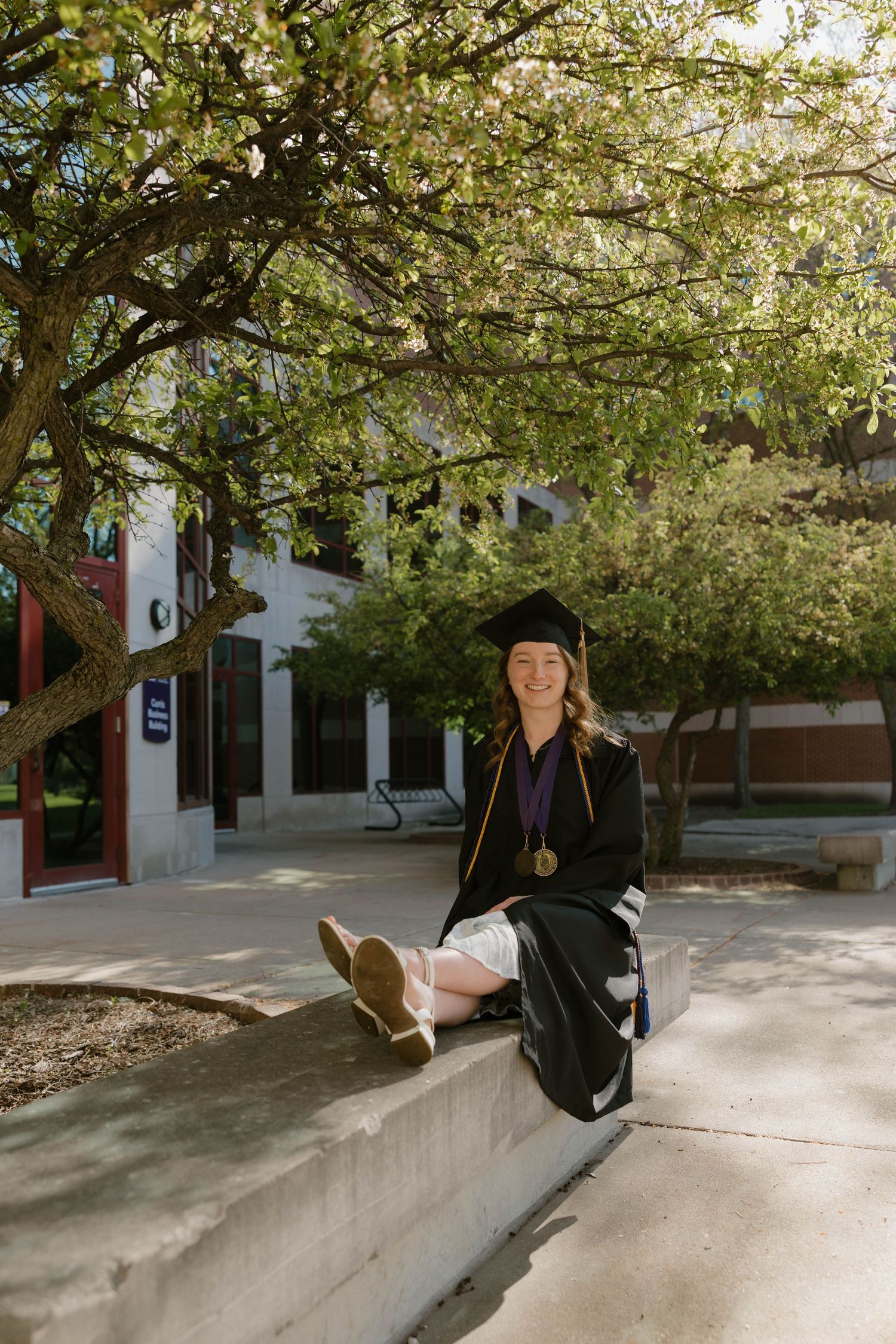 College senior wearing a graduation cap and gown