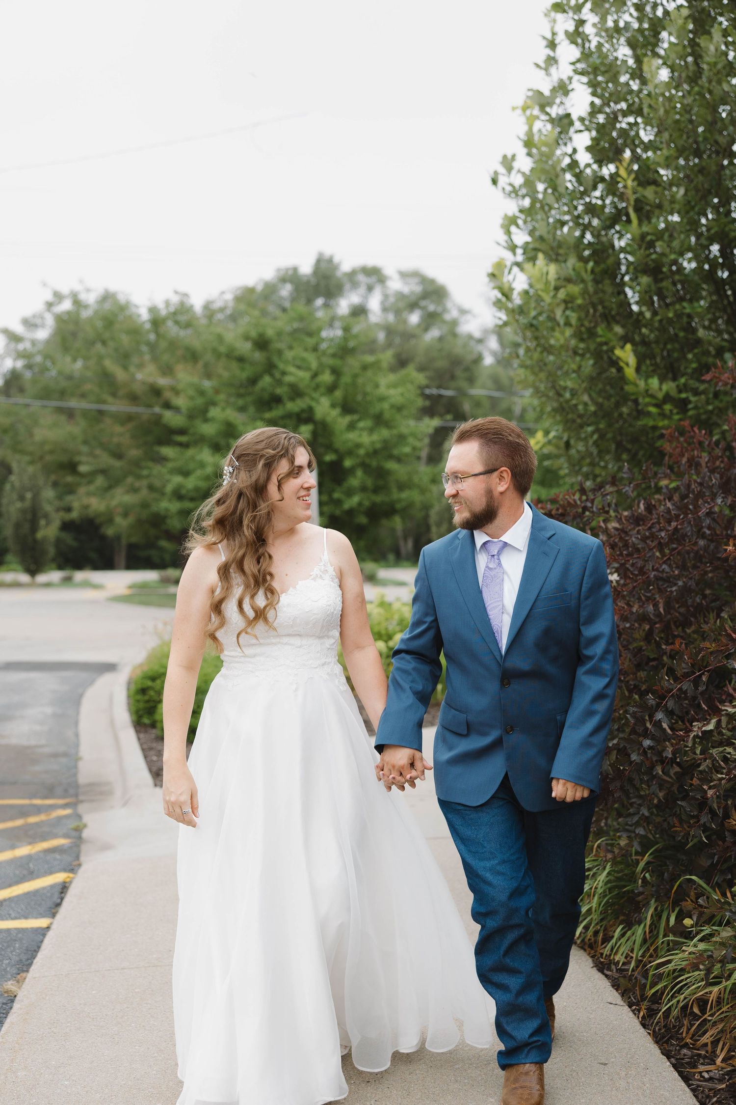 Bride and groom standing together during an outdoor portrait session