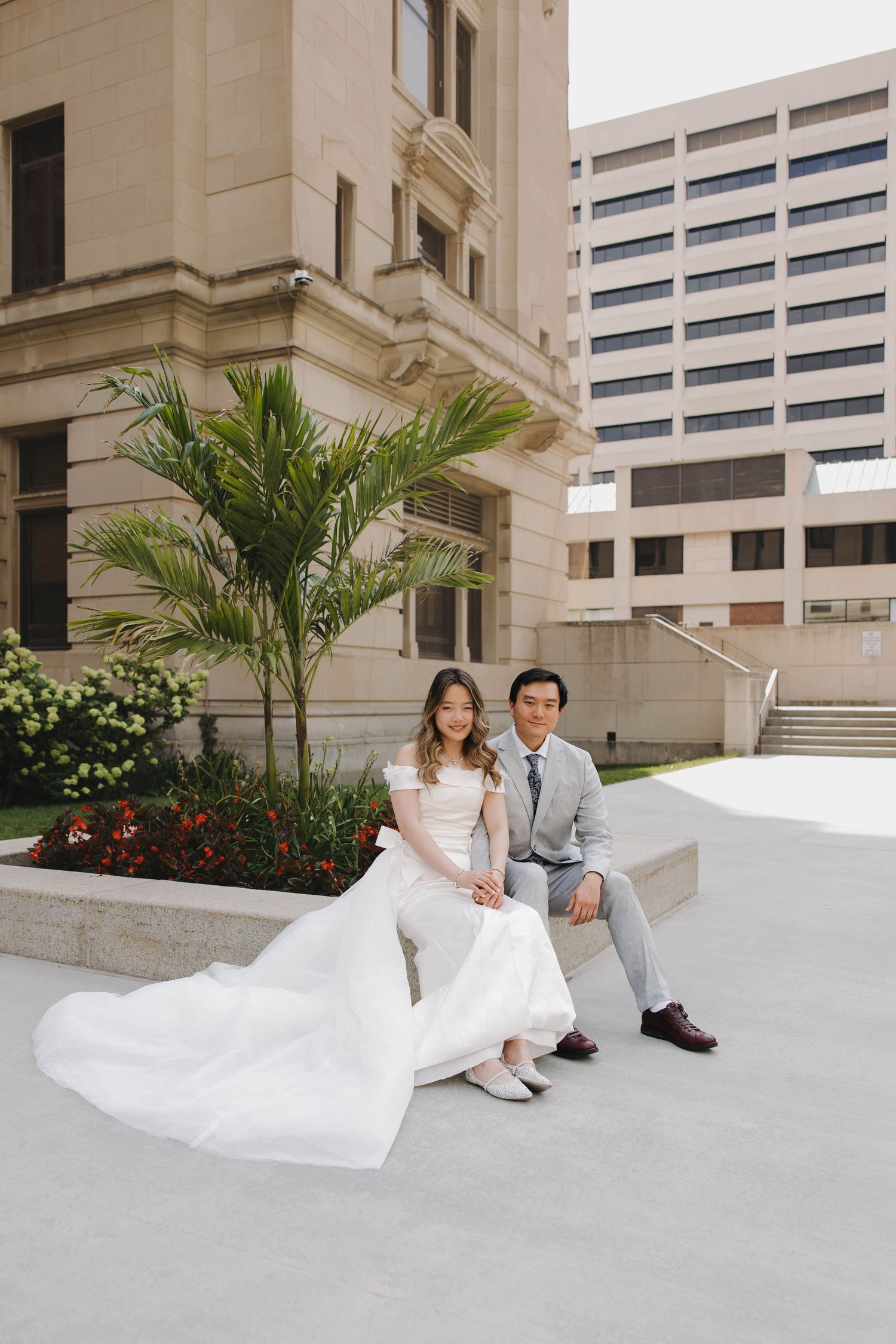 Newlyweds laughing together outside the courthouse