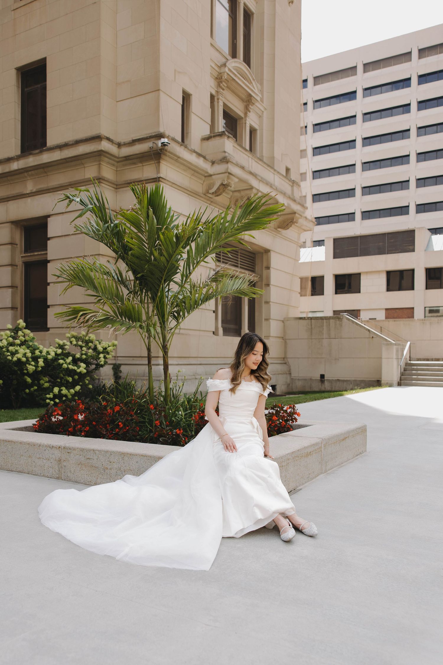 Bride posing outside of downtown omaha courthouse