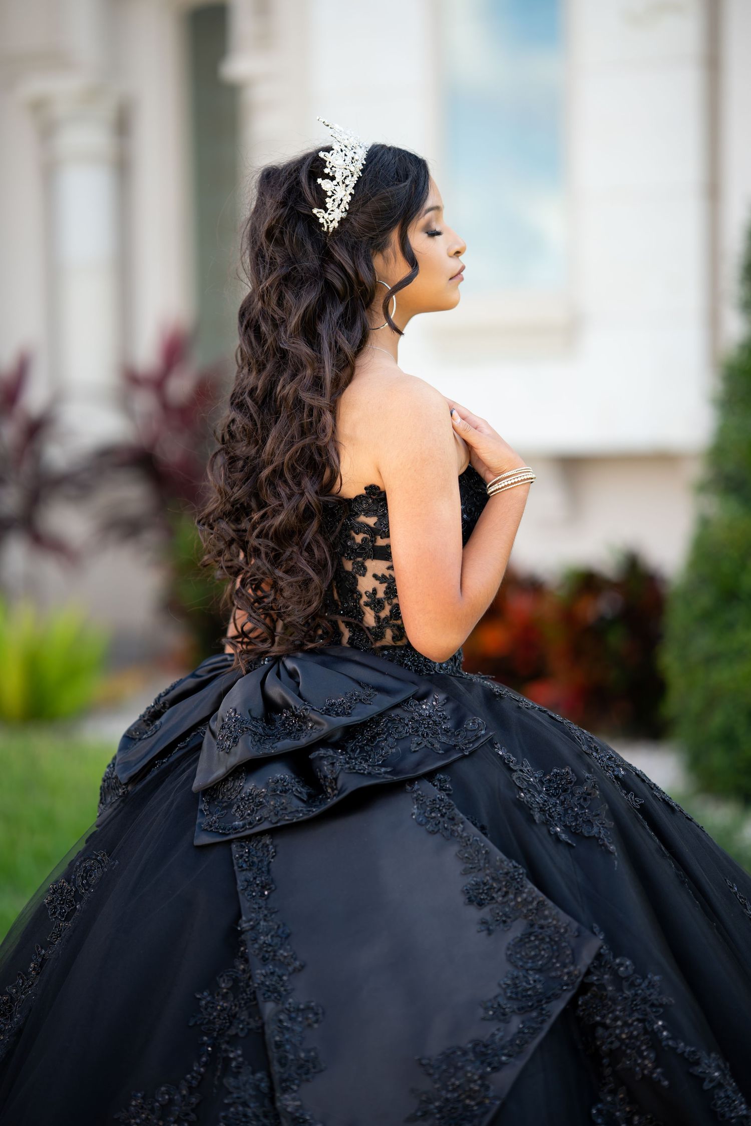 Quinceañera portrait in an elegant black gown with detailed lace and tiara