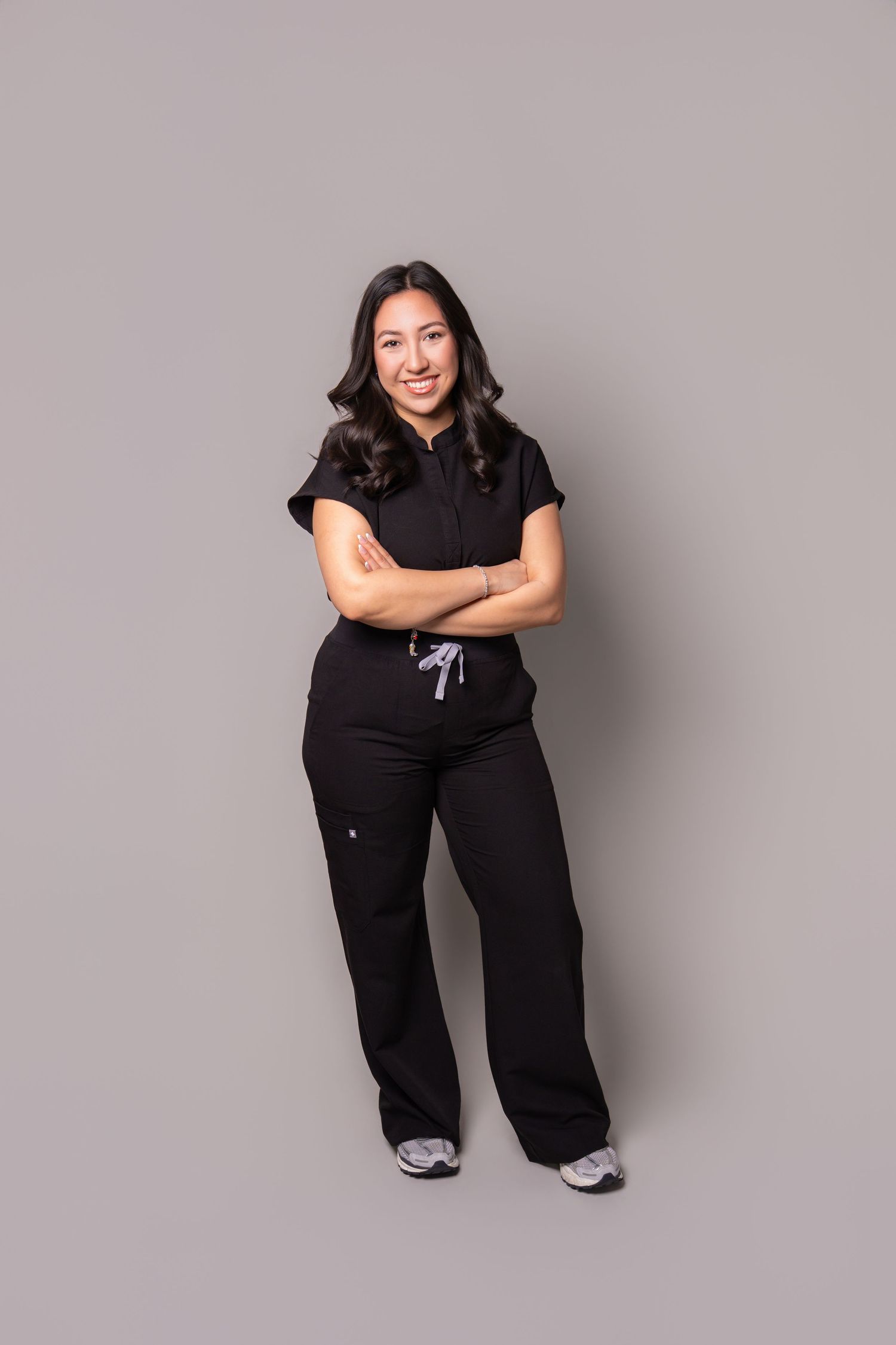 Professional woman posing for a studio headshot on a neutral background