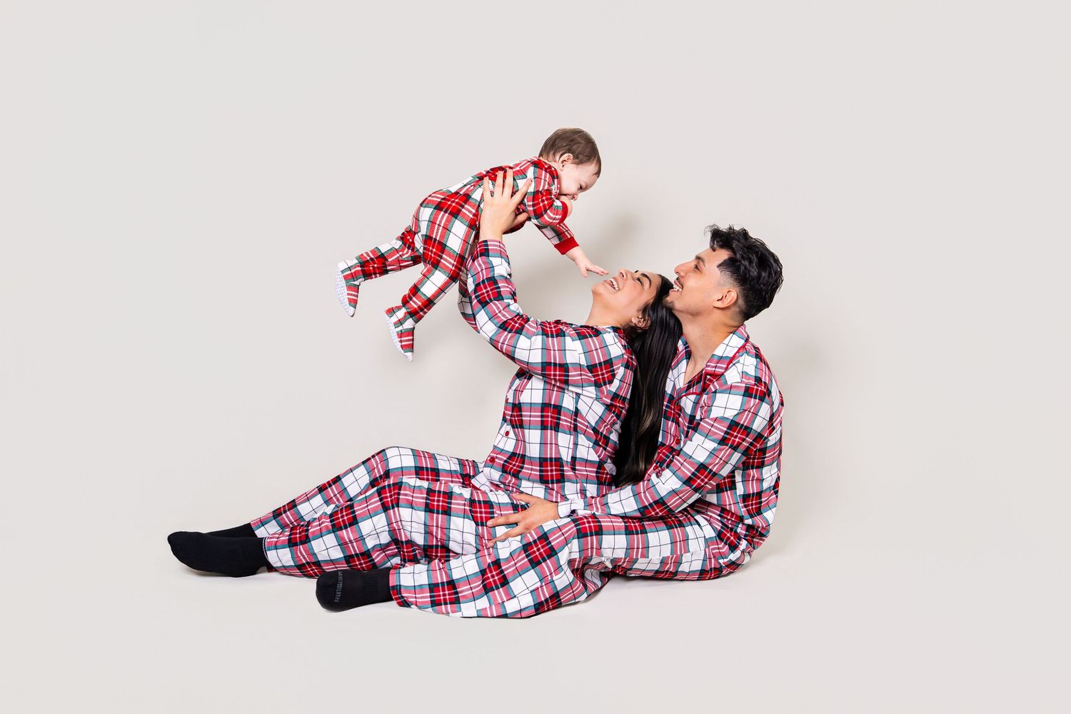 Parents playing with their baby during a family holiday studio session
