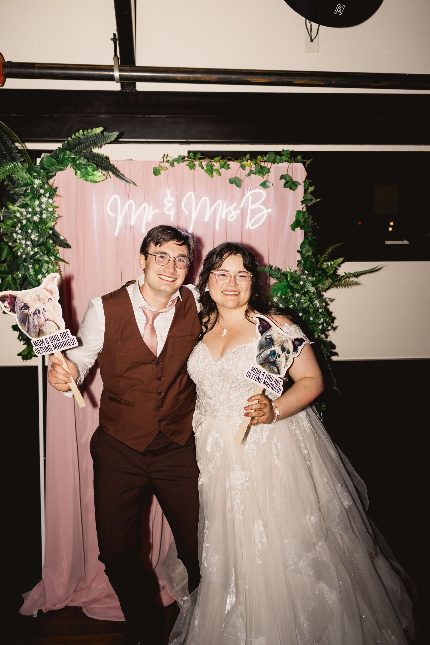 A series of wedding photographs showing a couple posing together against a pink backdrop.