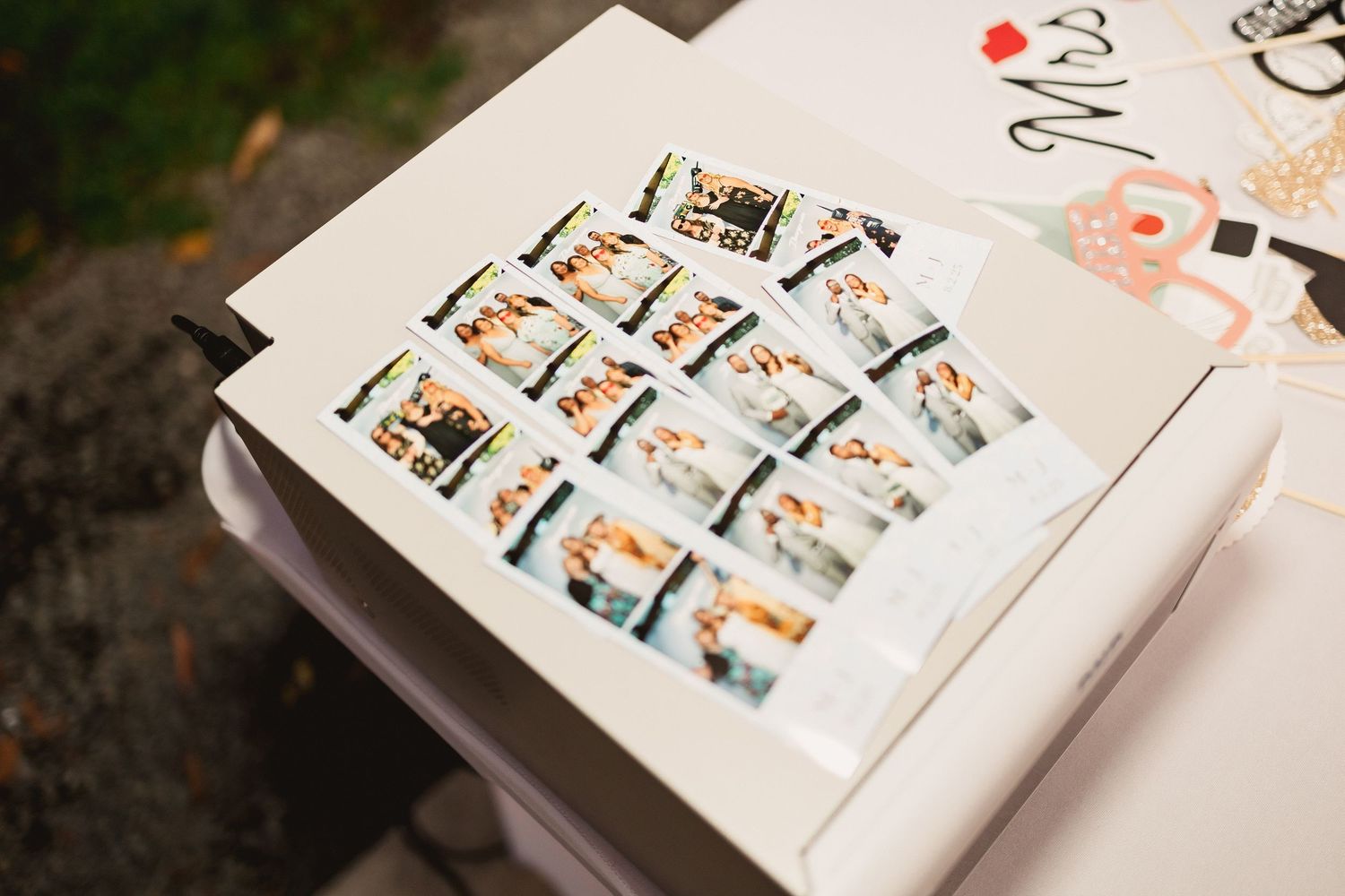 Photo album with multiple small polaroid-style photos arranged in a grid layout on a white page.